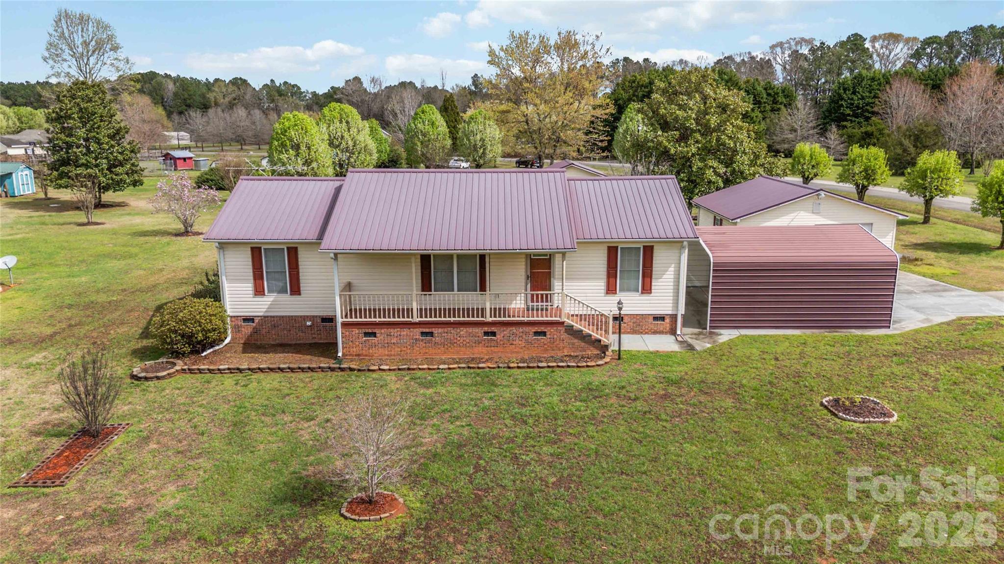 BACK ON MARKET AT NO FAULT OF THE SELLER! Charming 3-bedroom, 2-bath home on 1.33 acres featuring beautiful hardwood floors, fresh interior paint, and a welcoming rocking chair front porch. Situated on a level corner lot with a beautifully manicured yard, this property offers space, comfort, and functionality. Enjoy outdoor living with a screened back porch and deck overlooking the spacious yard. Additional features include a metal roof, a two-car carport, a detached one-car garage, a workshop, and a storage building, ideal for hobbies, storage, or extra workspace. Plenty of room for outdoor activities while still being convenient to York, McConnells, and Rock Hill for shopping, dining, and commuting. A wonderful opportunity to enjoy country living with modern conveniences nearby.