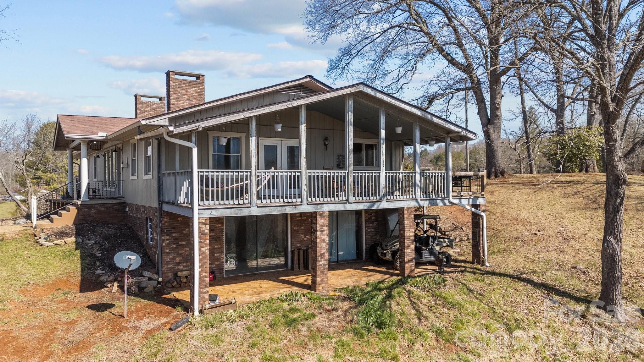 Incredible location, 4000+ sq ft raised ranch in Franklin, on almost 14 acres. The property offers unparalleled flexibility, ideal for a homeowner or developer creating a unique opportunity to create their vision. There are views of the Great Smoky Mountains from the wrap around porch, and nearly every window! Enjoy over 500 ft of beautiful river frontage. There's classic charm and character including oak hardwood floors throughout the main floor and two beautiful stone fireplaces. The rooms are all substantial in size. The Seller has meticulously improved the land and renovated most of the home. There is a one car garage, work shop, storage room, full bath, bonus/flex room and potential fourth bedroom in the lower level. The location offers the perfect combination of seclusion and convenience with a five minute drive to shopping, dining and schools. Property consists of two parcels. Schedule your showing today! Public Sewer available!