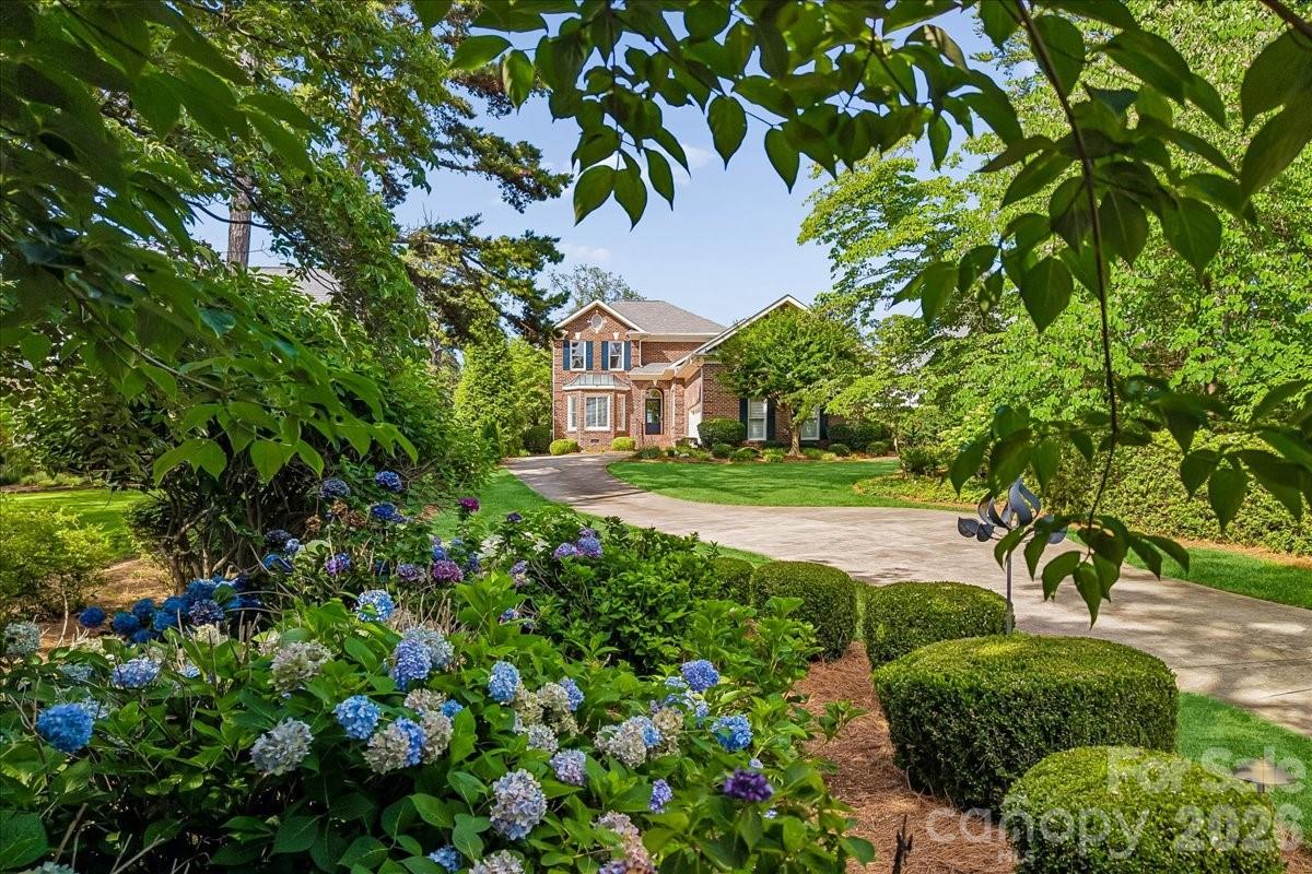 Renovated to perfection and perfectly positioned on the 3rd green in the highly sought after The Peninsula community, this home offers an exceptional blend of lake and golf course living. Enjoy peaceful mornings on the all seasons porch, Fourth of July fireworks from your backyard, and evenings spent watching the sunset over Lake Norman before returning to your deeded boat slip just moments away.

Comprehensively renovated in 2023, every space was thoughtfully reimagined for today's lifestyle. Improvements include converting the formal living room into a main-level secondary bedroom, transforming the half bath into a full bath, expanding the primary suite closet with a stackable washer and dryer, adding a dedicated laundry room, adding hardwood flooring throughout the upper level, and extensive landscaping and fencing enhancements. High-end finishes, designer fixtures, and exceptional attention to detail are evident throughout.

The chef's kitchen features an expansive island, quartz countertops, custom cabinetry, generous pantry storage, a 36-inch induction range with hood, appliance garage, liquor cabinet, trash/recycling pullout, and integrated storage solutions designed for both beauty and function. The adjoining great room is anchored by a new fireplace and mantle with custom built-ins and designer lighting.

Filled with natural light, the main level primary suite offers direct access to the backyard, and a luxurious spa inspired bath featuring an oversized multi-head shower, freestanding soaking tub, custom cabinetry, and abundant storage. The custom walk-in closet includes a conveniently located stackable washer and dryer.

Separate upper levels create endless possibilities. The room above the garage has an en-suite bath and easy access storage. Upper-level bedrooms share a hall bath with one bedroom capturing a seasonal view of the lake.

The beautifully landscaped backyard was designed to maximize privacy and enjoyment, featuring ambient lighting, mature plantings, and picturesque golf course views. Preliminary pool approval has already been obtained, offering the opportunity to create the ultimate outdoor retreat.

Conveniently located near The Peninsula Golf Club, The Peninsula Yacht Club, dining, shopping, I-77, and Charlotte Douglas International Airport, this meticulously maintained home presents a rare opportunity to enjoy the best of Lake Norman's premier lake and golf lifestyle.