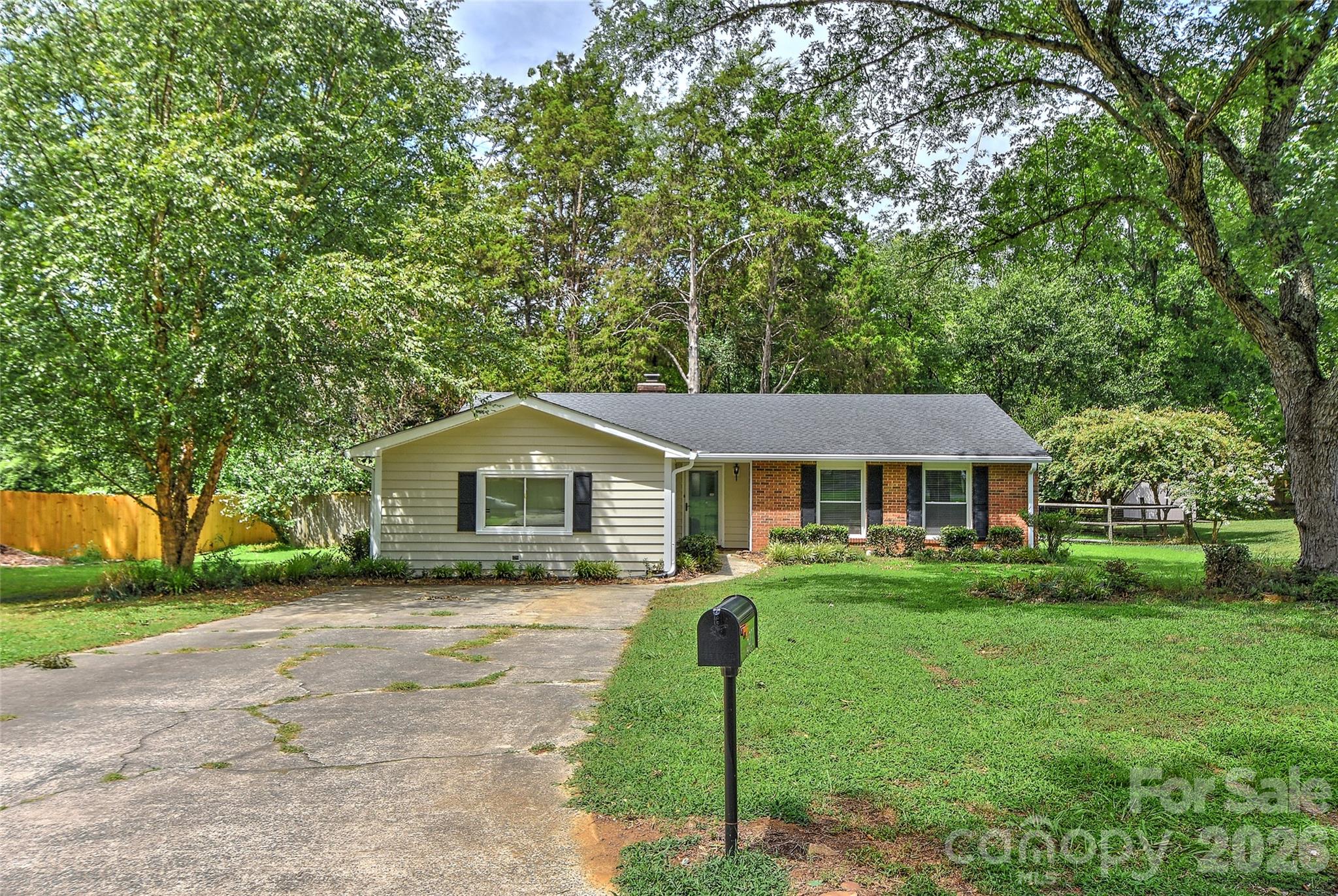 Wow- can't beat this location!  3 bedroom with 2 full baths ranch style home in South Charlotte on a flat over .30A lot with an awesome & new as of October 2025 screened in porch with wooden floor & ceiling, ceiling fan with light, recessed lighting off the great room plus a stamped concrete patio for grilling or chilling & sidewalk to gate.  Front entry opens up to the great room that features vaulted ceiling, true brick masonry fireplace with wooden mantle and a kitchen pass through window, as the party is always in the kitchen.  Kitchen flows and has SS double door refrigerator & bottom freezer included, newer quartz counter tops, updated sink & faucet.  Range/oven is electric, SS dishwasher & plenty of storage.  Newer cabinetry with cutting board counter tops & builtin beverage cooler in breakfast area and a pantry!  Big primary bedroom tucked in the back of the home w/updated bath.  2 secondary bedrooms good sizes with ceiling fans and hall bath.  And let's not forget the big bonus room with new flooring July 2026.  Room has wall unit for heat & cooling.  Laundry is in the mud room with exterior side door, sink and plenty of storage space and washer (2022) & dryer (new 6/2026) included!  HVAC only 7 years old and previous owners said roof installed 2017.  Community features a small lake within neighborhood.