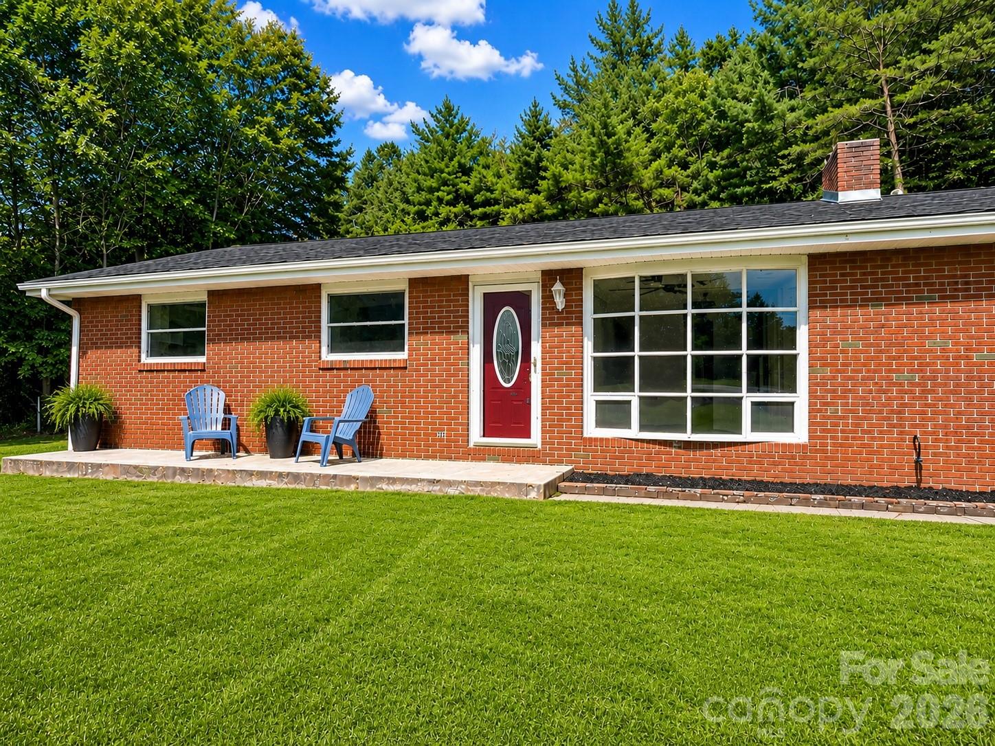 Perched on a beautiful piece of land with long-range mountain views, this classic brick ranch is the kind of home that invites you to slow down, breathe a little deeper, and imagine what's possible. Full of character and ready for its next chapter, this 3/2 home offers a wonderful opportunity to add your own style and updates while enjoying the peace of an established property.

Inside, you'll find fresh interior paint, a spacious pantry/laundry room, newer windows, and the confidence of a brand-new roof (July 2025) with a transferable warranty. The sunroom is truly the heart of the home...a place to sip your morning coffee while overlooking the garden, butterfly bushes, and fenced backyard where pets can roam and wildlife like deer and turkey often stop by for a visit.

The attached two-car garage offers additional attic storage, while a separate workshop, studio, or garage sits just above the home with its own driveway, and also has that brand-new roof (July 2025), and an estimated value of approximately $70,000. Whether you envision a creative workspace, home business, hobby shop, or explore the potential for an accessory dwelling unit (subject to buyer verification), the possibilities are exciting.

Tucked away just enough to feel like your own private retreat, yet only 5 minutes from Biltmore Lake, 15 minutes to West Asheville, 20 minutes to downtown Asheville, and 30 minutes to Waynesville, this property offers the best of both worlds. If you've been searching for a home with solid bones, an exceptional setting, and the chance to create something truly your own, this is one you'll want to experience in person.