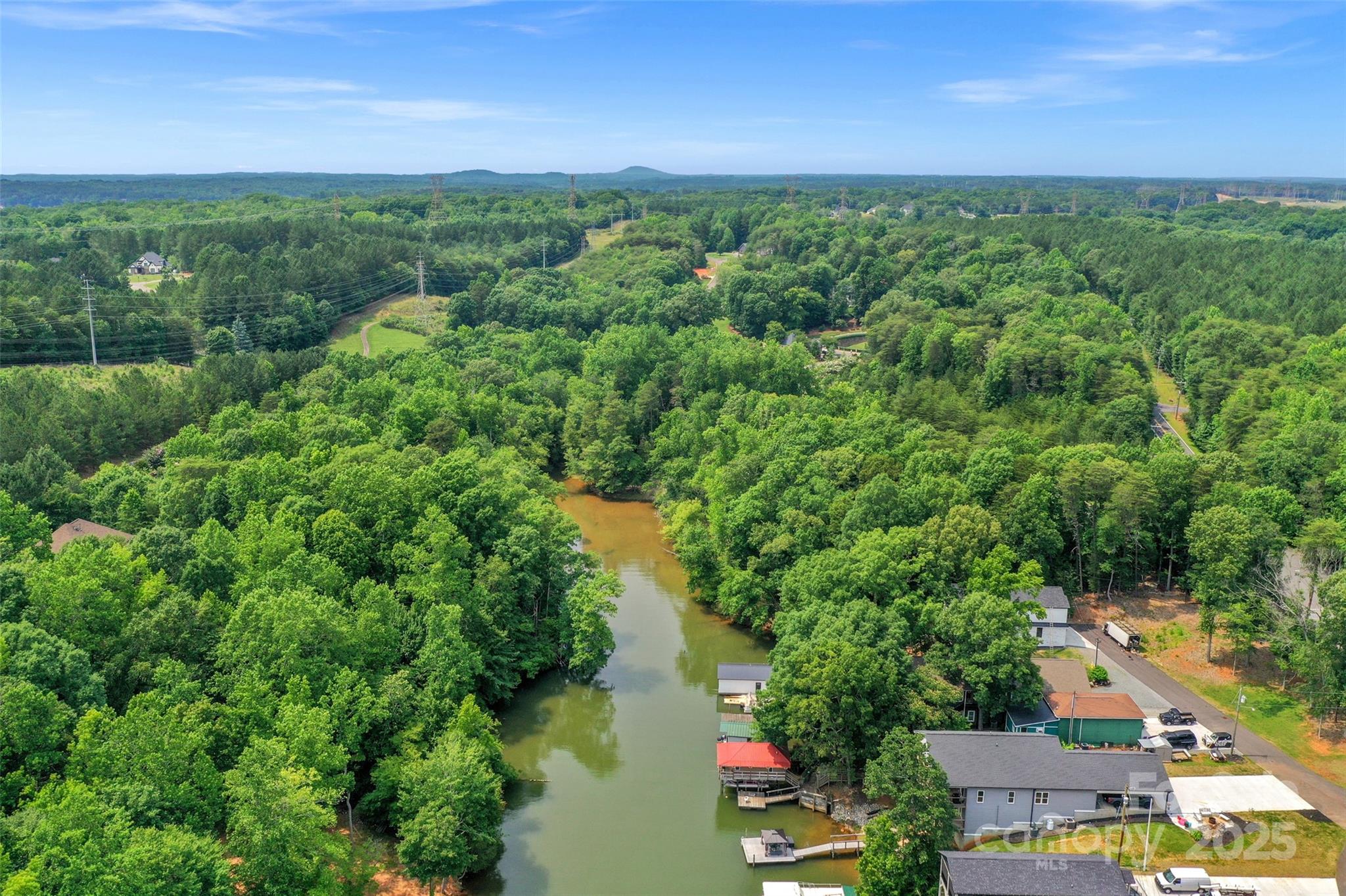Experience the pinnacle of Lake Wylie waterfront living with this exceptional 300-foot-deep lot located in the prestigious gated community of Reflection Pointe. Perfectly engineered for a custom walkout basement home, the lot’s generous depth provides ample space for a private backyard oasis and pool area. Positioned in a future residential shoreline area according to Duke Lake Services, this property offers the potential for a private dock. With favorable water depth, residents can enjoy direct access to the Lake Wylie main channel for boating, kayaking, paddleboarding, and jet skiing. As a "true" custom home community in Belmont, NC, Reflection Pointe maintains high architectural standards with a minimum of 2,000 HLA for ranch-style homes and 2,400 HLA for two-story residences. There is no timeframe to build, allowing you to secure your land now and design your dream home when ready. The community features a robust amenity package, including a luxury clubhouse, pool, tennis courts, paved walking trails, a soccer field, and a waterfront pavilion with a community beach. For outdoor enthusiasts, the neighborhood also provides a marina and dedicated boat/RV storage. Ideally located just 10 minutes from Downtown Belmont’s breweries and retail, 20 minutes from CLT Airport, and 30 minutes from Uptown Charlotte, this lot is the ultimate choice for those seeking a private, high-end lake lifestyle.