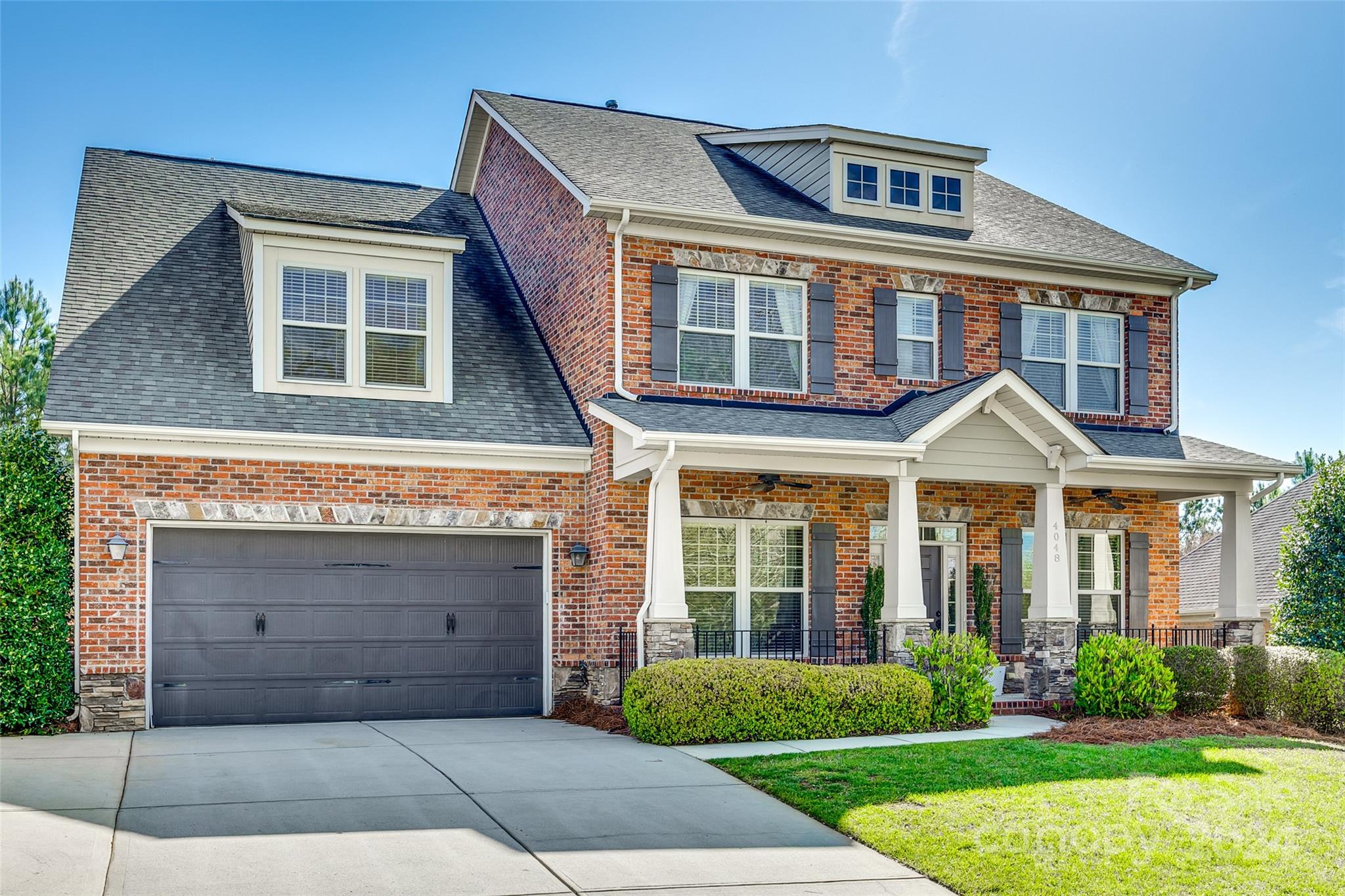 Welcome to this stunning full brick home located in the sought-after neighborhood of Barber Rock in Indian Land, SC. Upon arrival, you are greeted by a charming rocking chair front porch, perfect for enjoying your morning coffee or relaxing in the evening. Entering the home you will notice the hand-scraped flooring, dedicated office space & formal dining room. The open floor plan features a spacious living room with stone fireplace. The kitchen has a large island, ample counter & cabinet space & SS appliances. Upstairs features 4 bedrooms plus a 5th bedroom/bonus room. The primary bedroom is spacious & the primary bathroom features a separate shower & tub, dual vanities & leads to a large walk in closet. Outside, you will love the screened porch & the large patio is the perfect spot for grilling and entertaining. This home has solar panels that nearly eliminates the power bill & a home water filtration system. The Barber Rock community has an outdoor pool, clubhouse & playground.