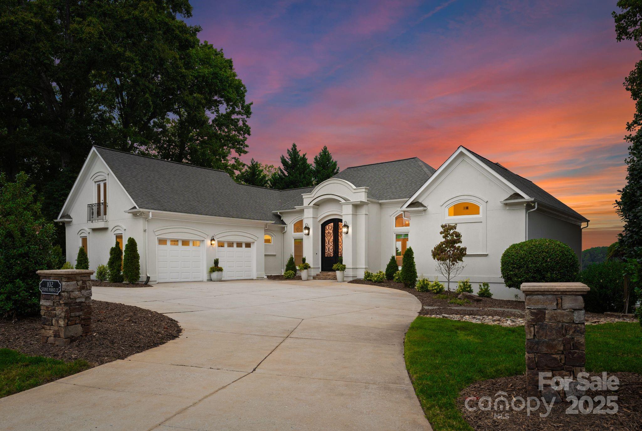 Located in one of Lake Norman’s most exclusive private peninsulas, Sunset Veranda is a private waterfront retreat that offers an unparalleled blend of luxury and lifestyle.  150 feet of pristine shoreline set the stage for breathtaking views. Step inside to be greeted by a gallery of floor to ceiling windows, allowing you to be bathed in natural light and the beauty of the view.  Enjoy main level living and a large luxury primary suite with updated spa bath and custom closets.  Take in the Lake Norman lifestyle while entertaining your guests on the expansive main level veranda.  The lake level living provides extra bedrooms and a large second living area to accommodate your guests or to enjoy your lake life. This home features soaring ceilings, floor-to-ceiling windows, teak floors, and a gourmet quartz kitchen with top-tier stainless appliances.
Step outside to your own lakeside paradise, with your own double deck pier featuring two boat lifts, deep water access, and an expansive sun deck perfect for entertaining or soaking in the sweeping views and room for a pool. Option to join The Point for world-class amenities, this home delivers the ultimate in privacy, elegance, and waterfront living.