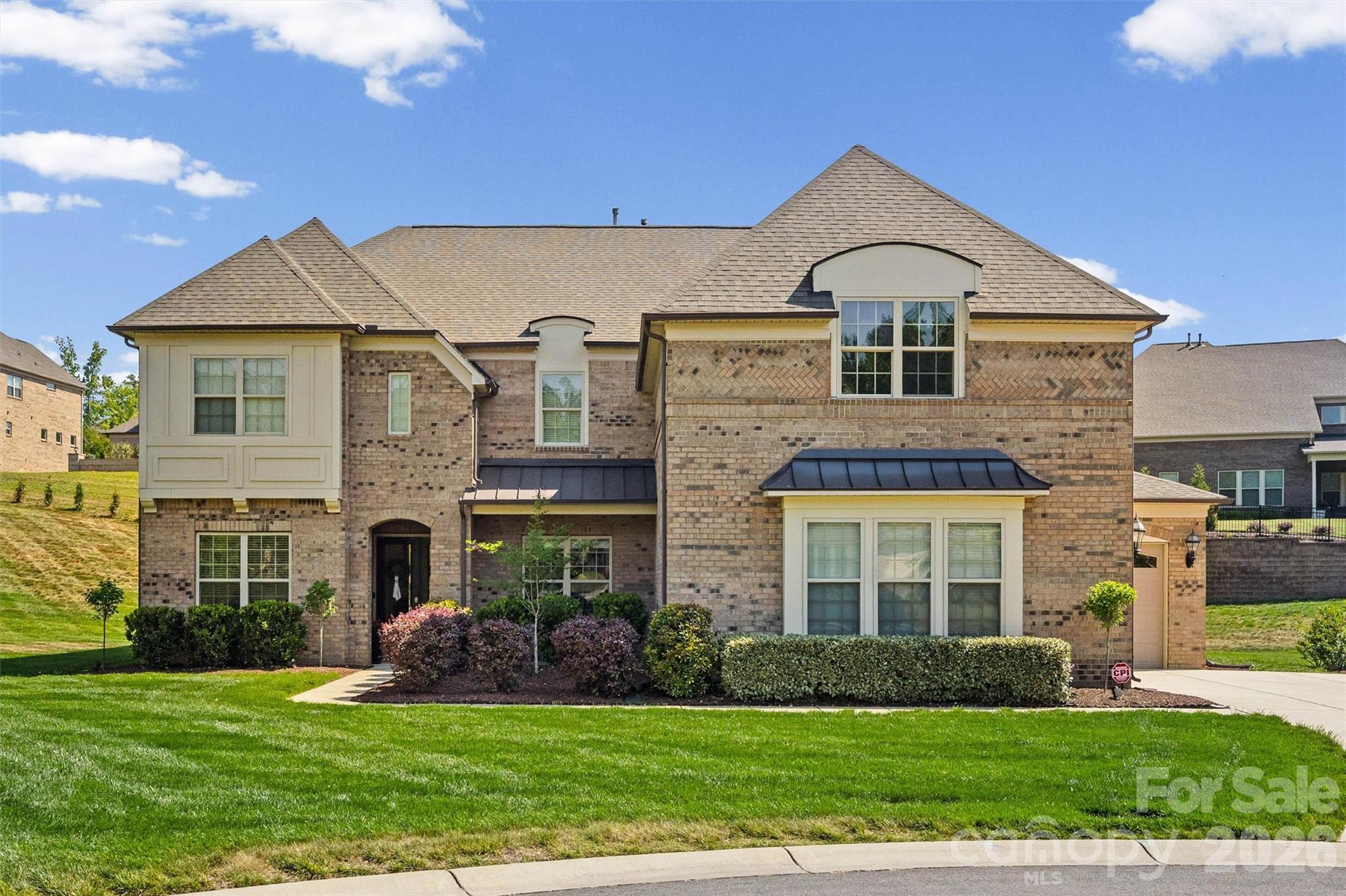 Welcome to a truly special home in Bridgemill, quietly set on one of the community’s largest estate lots. Tucked away on a private 0.75-acre cul-de-sac, this full brick home offers a thoughtful blend of classic style and modern comfort. Built in 2020 and meticulously cared for, it features a 3-car garage and a layout designed for both everyday living and entertaining. Step inside to a bright, two-story foyer with natural light and a soft, neutral palette. The Great Room is spacious and comfortable, with a coffered ceiling and a stacked stone gas fireplace that naturally becomes the heart of the home—perfect for gatherings. The kitchen, a show stopper, is both beautiful and highly functional-- ceiling-height cabinetry, glass-front accents, under-cabinet lighting, a statement vent hood, stainless steel appliances, and a large island that makes cooking and hosting easy. A butler’s pantry and generous walk-in pantry add convenience and storage without sacrificing style.
The main level also includes a private guest suite/ attached full bath, a dedicated home office, a sunroom filled with natural light, a formal dining space, a drop zone, and an additional flex area or tech nook—offering flexibility for how you live and work.
Upstairs, the primary suite is a comfortable retreat with its own sitting area, a cozy electric fireplace, and a spa-like bathroom. Three additional bedrooms each have their own bathrooms and walk-in closets, offering plenty of space and privacy. There’s also an unfinished storage area (over 160 square feet) accessible from one of the guest bedroom closets—ideal for future expansion or extra storage. A large bonus room and walk-in attic add even more versatility. Out back, the home really shines. The newly built outdoor living space has been carefully designed to feel both relaxing and functional, with a covered porch, travertine decking, a custom fireplace, and space for an outdoor TV. The outdoor grill setup and custom fireplace were professionally designed and installed by Sun South, adding both quality and craftsmanship to the space. The perfect setting that works year-round.
Additional thought out features of the home include epoxied garage floors, an electric car charger, and a double water filtration system—small details that make a big difference in day-to-day living.
All of this is located in the highly sought after Bridgemill community, known for its resort-style amenities, including clubhouse, two pools, tennis courts, a clubhouse, pocket parks, walking trails, and a fitness center.