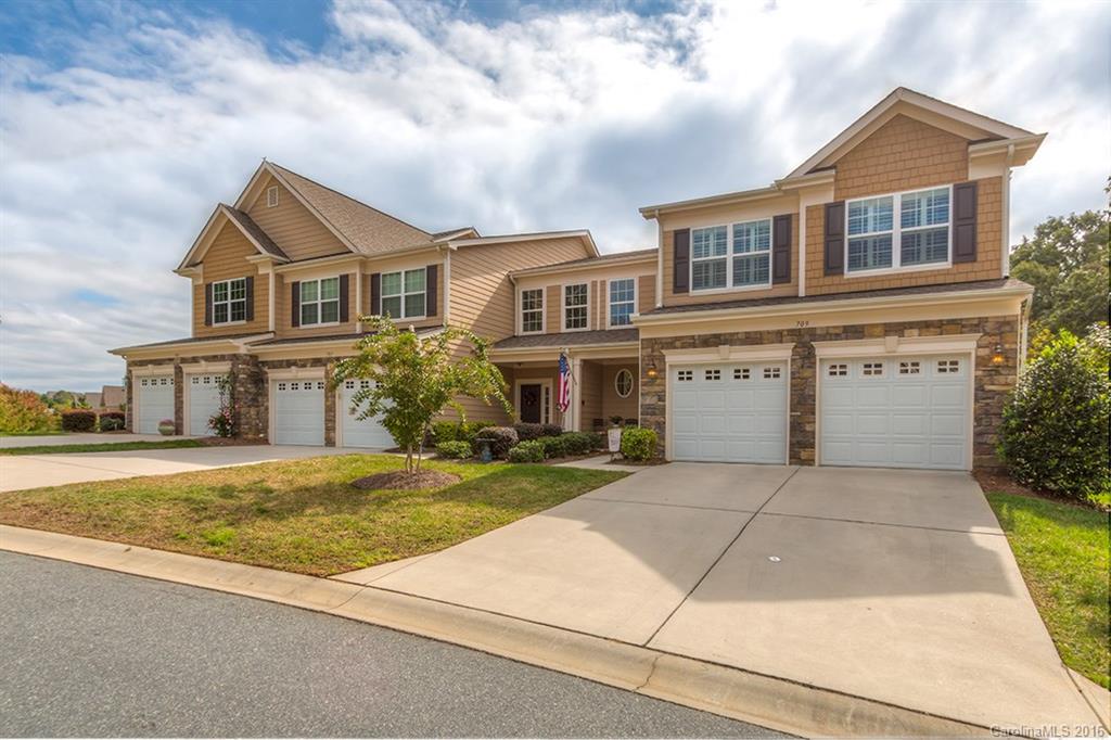 This Lake Wylie community has it all..A marina with boat storage; nearby Golf Course with clubhouse and restaurant; the greenway perfect for walking, horseback riding, or just relaxing; recreation fields; pool; Quick access to I-77, Charlotte and more. This lovely end-unit townhome overlooking the 18th green, the pond, and the woods has the master suite on the main level, has the newly updated hardwoods, custom built-ins, cabinets, and more. The Good Life is here, so Come Home to Deerbrook Lane.