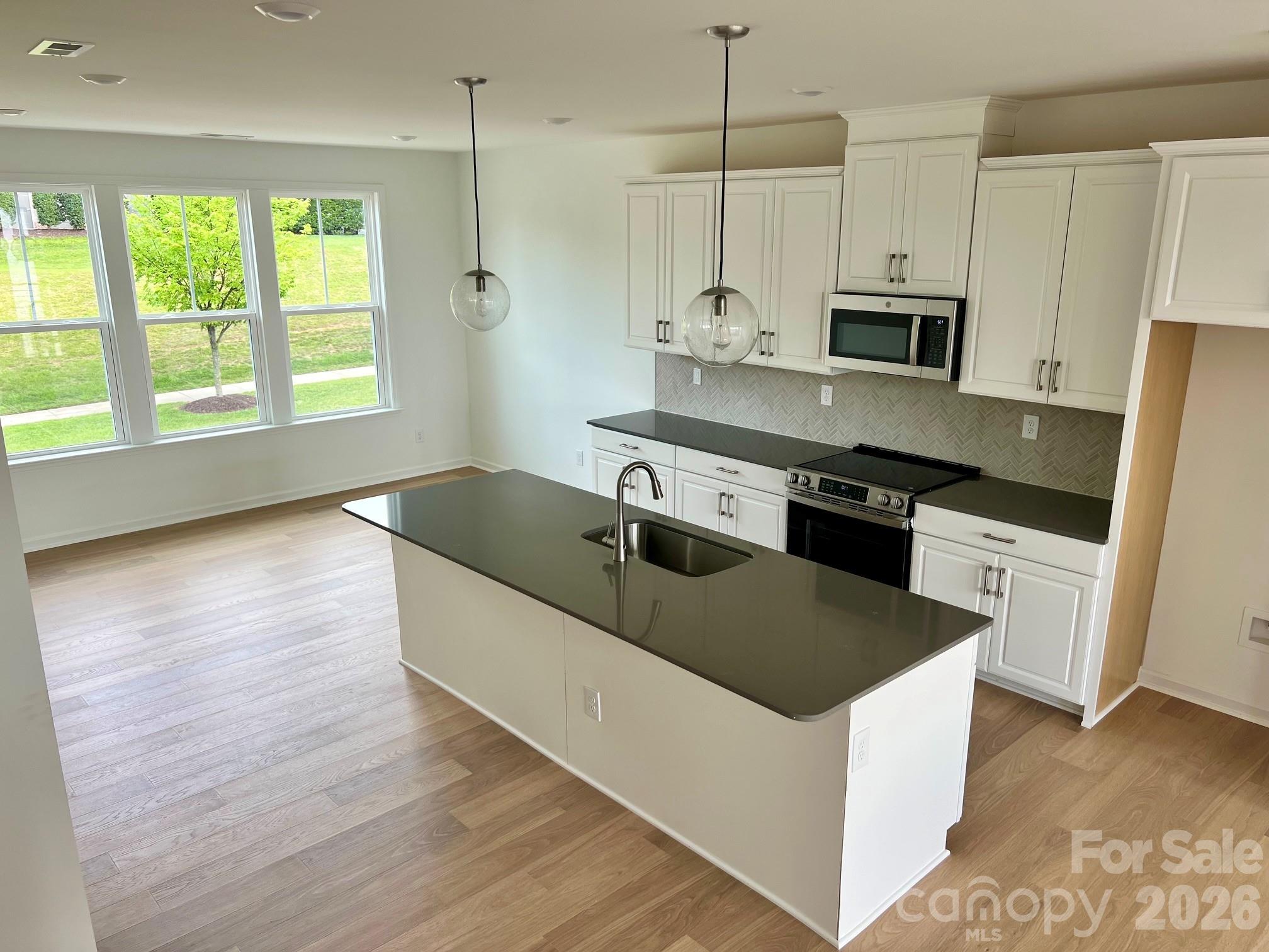 What's Special: Corner Lot | East Facing Patio | Premium Location | Mud Room | End Unit | Model Plan. New Construction - July Completion! Built by America's Most Trusted Home Builder. Welcome to the Breckenridge II at 1804 Alexander Village Main Drive in Senata at Research Park! On the ground floor, an inviting foyer leads to a spacious flex space with a convenient half bath, easily accessed from the main entrance or the two-car garage. The second level opens into a bright, open-concept living area with a generous great room that extends to a charming deck, alongside a welcoming kitchen with a large center island and a casual dining space with an adjacent powder room. Upstairs, two comfortable secondary bedrooms share a full bath, with a centrally located laundry area adding everyday ease. Tucked privately on the opposite end, the primary suite feels serene with a generous walk-in closet and a spacious bath featuring dual sinks and a beautifully appointed shower. Welcome to Senata at Research Park in Charlotte, NC. Enjoy on-site favorites like Starbucks and Chipotle, with Trader Joe’s and local dining just across the street. Research Park and Vanguard Campus are moments away. With major highways and the Lynx Blue Line nearby, these townhomes offer easy access to Uptown Charlotte, work, school, and weekend fun. Additional Highlights Include: shower ledge in the primary bathroom. Photos are for representative purposes only. MLS#4366875