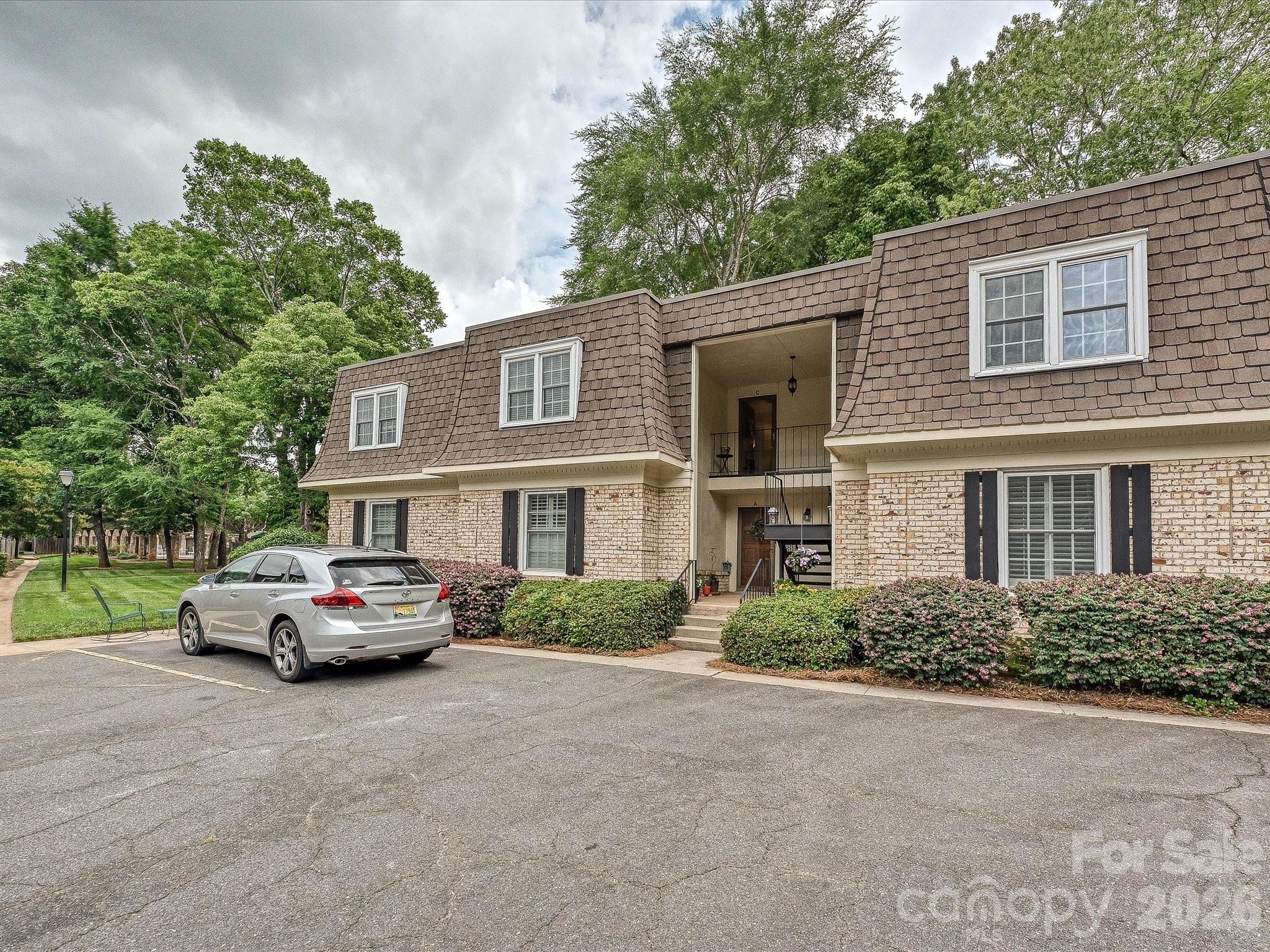 Charming second-floor condo in coveted Trianon offers a rare blend of space, accessibility, and SouthPark convenience. This light-filled home features a formal foyer, generous den with gas-log fireplace, and two true bedroom suites with excellent closet storage. The kitchen includes granite counters, updated appliances, and efficient workspace, while the formal dining room flows to a bright sunroom that lives like an additional sitting room or office. Classic brick-clad community with mature trees, pool, and clubhouse, plus reserved parking just steps from the building. All of this in the heart of SouthPark, moments to SouthPark Mall, Symphony Park, boutique fitness, greenway access, and some of Charlotte’s best dining and everyday conveniences—an opportunity to secure one of the area’s most established, accessible addresses at an approachable price point.