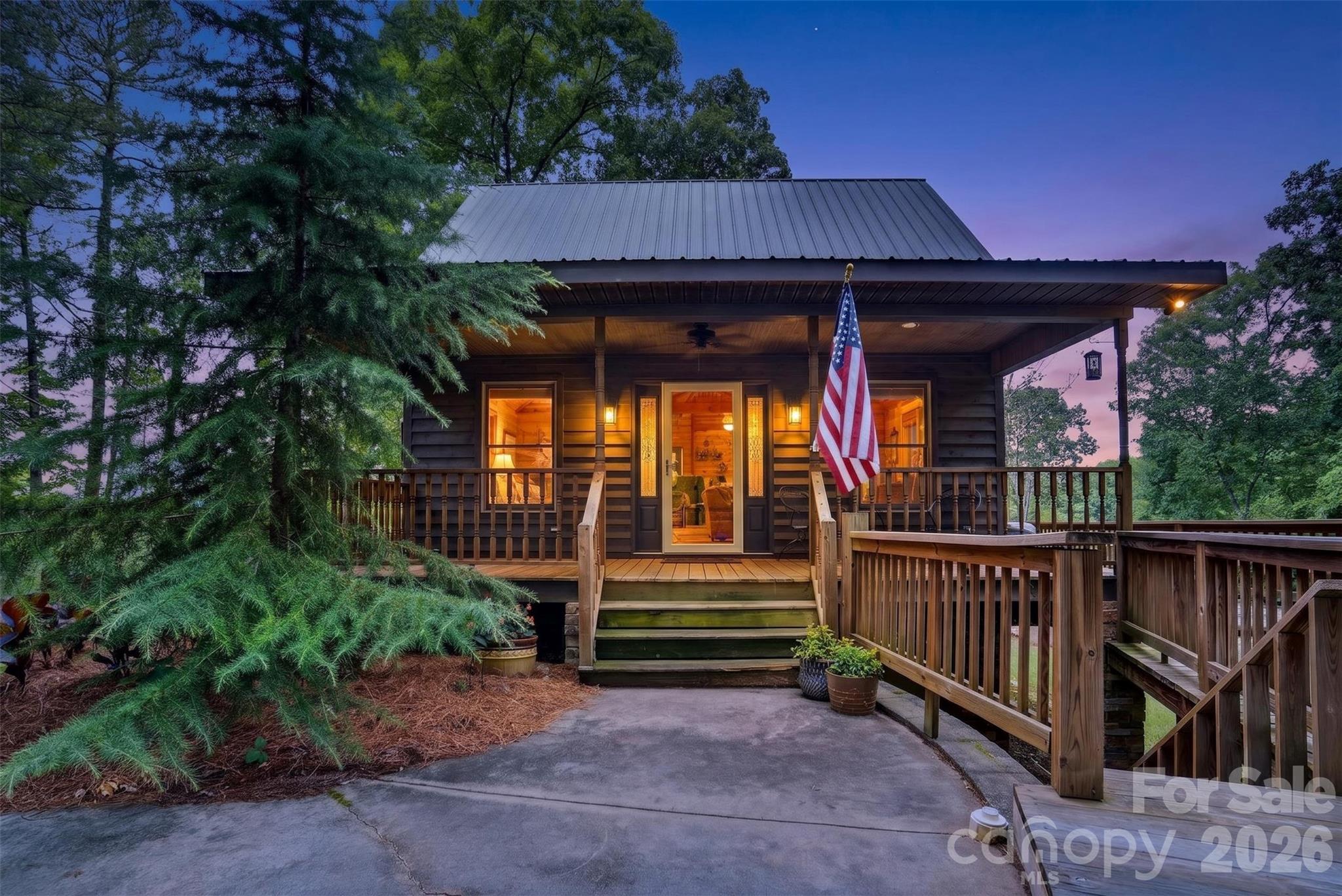 Lakeside Living & Rental Potential at Badin Lake! Escape to this stunning, wood-interior cabin combining rustic charm with investor appeal. Positioned on a prime corner lot on the lake side of the road, this property boasts beautiful water views without the waterfront price tag. Inside, soaring wood walls surround a striking, central gas log fireplace that steals the show. The layout offers 1 bedroom, 1 bathroom, plus a versatile loft space that is currently used as a second bedroom and is ready for guest overflow. Take in the scenery from the expansive front porch, or head to the outdoor firepit for evening relaxation. An unfinished basement handles all storage and laundry needs. Sold fully furnished (minus couch), it is a turnkey short-term rental option or private oasis. Cruise by golf cart to the community access or use public ramps nearby. Currently on septic, but public sewer is available for future expansion. Leave your worries behind and tap into the lake lifestyle today!
