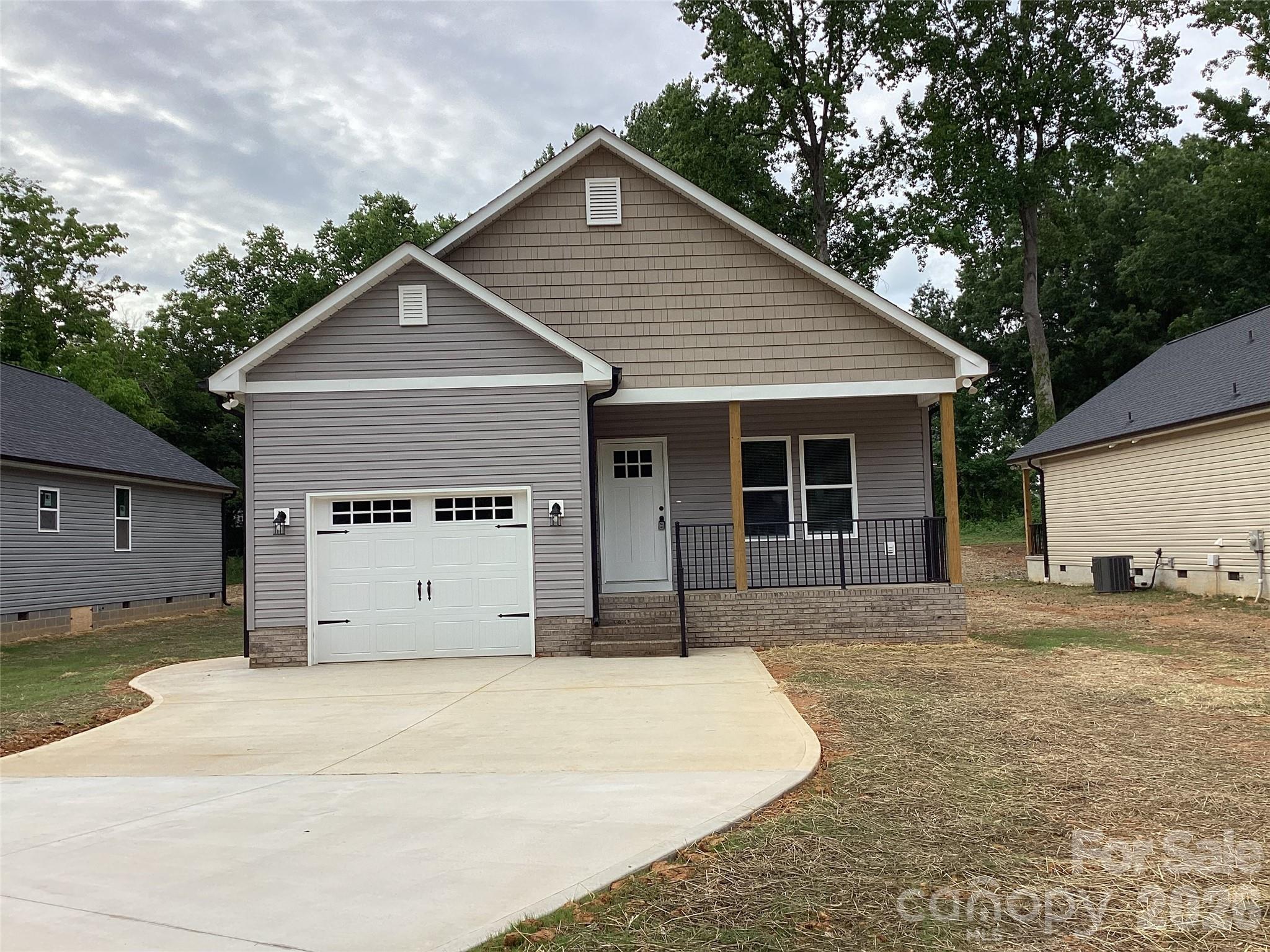 This brand new 3 bedroom/2 bath house is conveniently located within walking distance of numerous popular businesses and restaurants in Salisbury.  Once inside, an open living room and eat-in kitchen greet you, with vaulted ceilings making the space feel larger. A spacious walk-in pantry provides plenty of storage space and is located near the kitchen for quick and easy access. Granite countertops and custom cabinets adorn the kitchen as well as stainless appliances. Retreat to the master bedroom, which overlooks the rear porch and includes a step ceiling, adding a visual aesthetic overhead. The 4-fixture en-suite includes a walk-in closet behind a pocket door. Bedrooms 2 and 3 are identical in size and sit across from the master . The one car garage faces forward on this home and opens into a mud room as it enters the house. The concrete driveway, with ample parking, accesses the garage.
