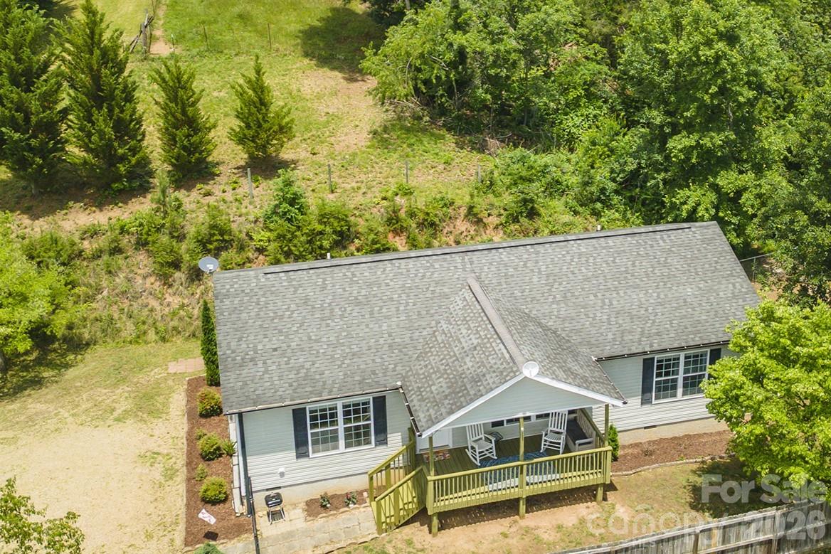 Charming Like-New 1-Level Home In A Country Setting - But Just 20 Minutes From Asheville!  3 Bedrooms, 2 Full Baths, 1540 SqFt, Large Living Room With Rock Gas-Log Fireplace, Dining Area, Large Kitchen With Breakfast Bar, Split Bedroom Floor Plan, Large Primary Suite With Walk-In Closet & Garden Tub & Separate Shower, Crown Molding Through Out, All Bedrooms Have Ceiling Fans, Laundry Room, New Heat Pump With Air (10 Year Warranty), Tilt Sash Windows, Hot Water Heater Is Only 2 Years Old, Custom Wood Blinds In Windows, Fresh Paint, New Tiled Low Threshold Shower With Rain Shower Head In Primary Bath, Whole House Water Treatment System, Long Range Mountain Views From A Large Covered Front Porch, Motion Detector Automatic Lights On Driveway, Home Is Wired For A Security System, Fenced-In Yard Area, Wheelchair Ramp On Back Porch, Large Parking Area, Located At The End Of A Cul-De-Sac For An Extra Sense Of Privacy.  Also Located Minutes From Weaverville & The Upcoming Novant Health Medical Facility & Mars Hill & Dining & Shopping & Entertainment.  This Property Offers A Wonderful Opportunity To Enjoy The Mountain Lifestyle While Remaining Close To The Energy And Culture Of Asheville And The Surrounding Communities.
