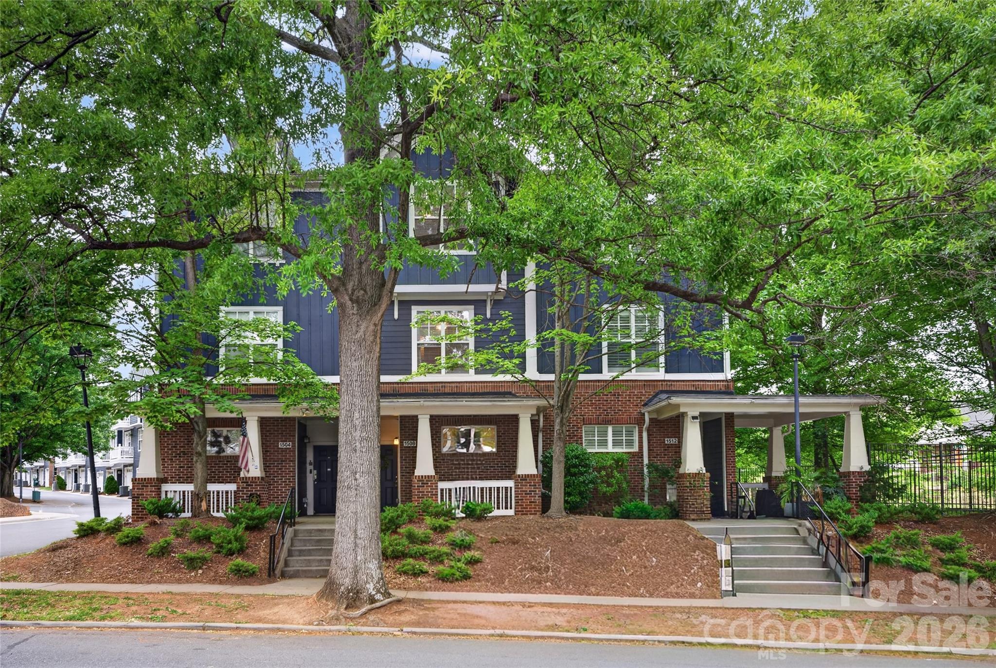 THE best value in Wesley Heights just got better!  Live just seconds to the Gold Line street car!  Amazing city views from this stunning townhome style condo! A huge highlights of this home is that each of the three bedrooms has their own private bathroom...plus a half bath for guests!  As you walk in, the lower level features a bedroom with an ensuite bath as well as garage access through the entry hall. On the main floor, you walk into the dining room that leads to the kitchen complete with breakfast bar, lots of cabinets, stainless steel appliances and access to the private back deck.  The large living room has great views of Uptown and is very spacious! Upstairs you will find two more bedrooms! Enjoy city views from the primary suite as well as the double closets.  The private bath features double vanities and an oversized garden tub. The other upstairs bedroom gets great evening light and has its own bath as well!  New carpet has just been installed and the home was repainted too!  All of this and more within feet of the street car stop to take you Uptown or over to Midwood.  Enjoy not having to drive to a concert or game! Not to mention all the great bars and restaurants in the sidewalk lined historic neighborhood of Wesley Heights and all the new spots in Freemore West. A short drive gets you anywhere, 2 minutes to I-77, 3 minutes to Uptown, 8 min to SouthEnd.  Seconds to Stewart Creek Greenway. HOA covers water and trash as well as community maintenance.