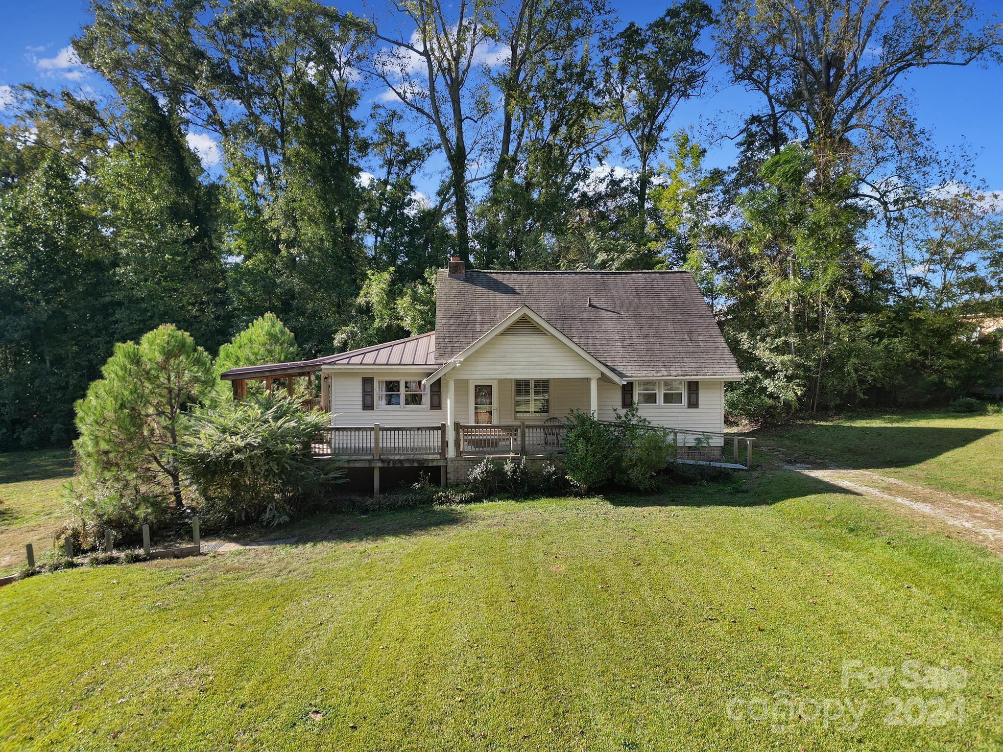 3 Bedroom 2 Bath Home w/detached 25 x 30 Workshop & 16 x 50 RV Cover on 1.29 Acres in a rural setting.  The home has a wrap around porch, unheated finished room upstairs, Gas Fireplace, kitchen appliances included, and updated bathrooms.  There is a small greenhouse included as well.  The hot tub needs work and is going to be 'as is".