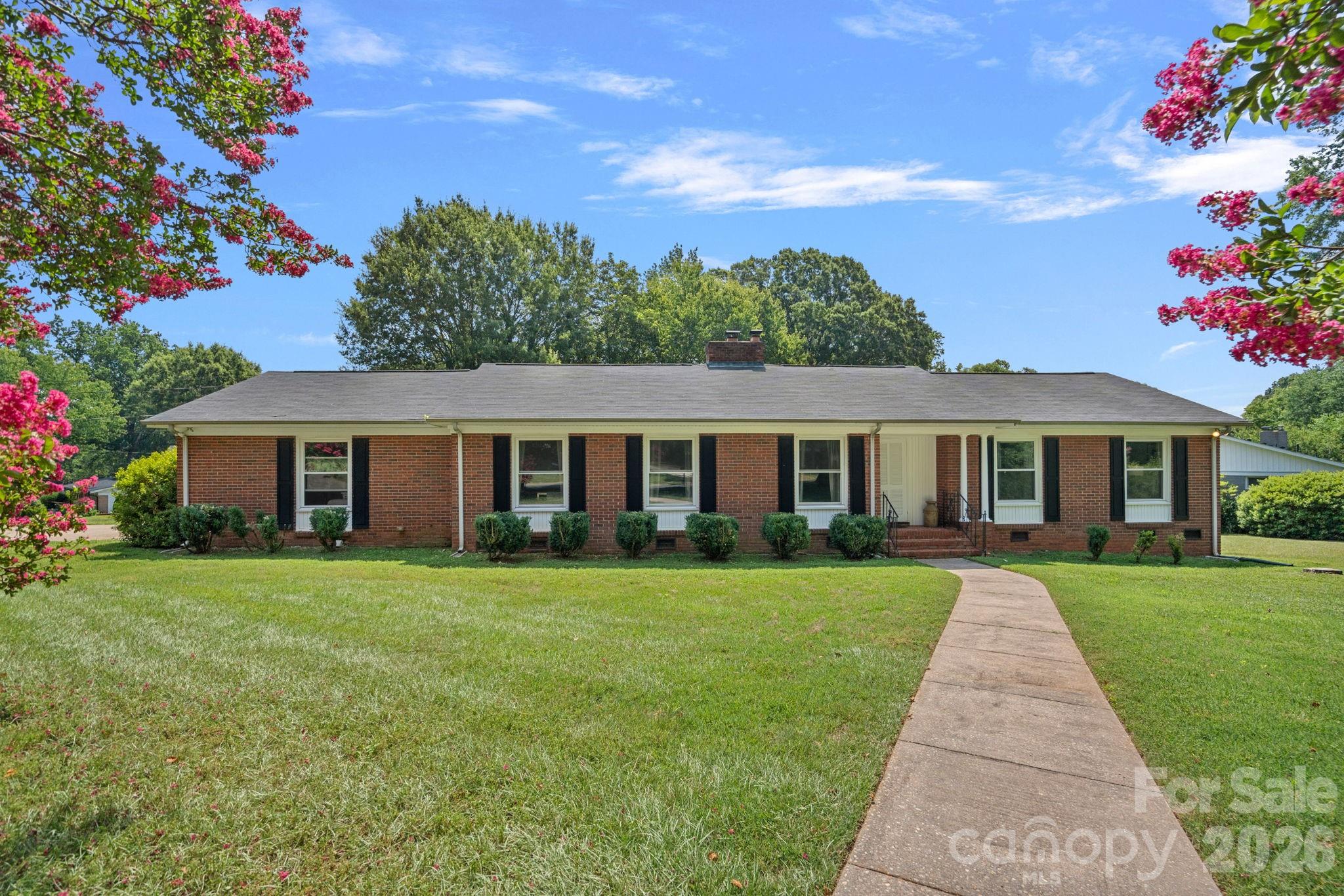 NEW SS GAS STOVE AND DISHWASHER GOING IN ON 7/15.  PICTURES WILL BE UPDATED!

Some homes simply feel different the moment you walk through the door.

Set on a spacious corner lot beneath mature trees, this classic full-brick ranch reflects the enduring craftsmanship and thoughtful design that continue to make homes of this era so desirable. Thoughtfully updated over the years while preserving its timeless character, it also offers the peace of mind that comes with major improvements already completed. Warm gathering spaces, beautiful natural light, hardwood floors, and a welcoming gas log fireplace create an inviting atmosphere you'll love coming home to.

Enjoy peaceful mornings on the screened porch overlooking the backyard, or spend evenings gathered with family and friends in the generous living and family rooms. Major improvements, including a roof replaced in 2018, all new windows in 2019, and a heat pump installed in 2024, allow you to appreciate the home's character with confidence.

Complete with an attached two-car carport, an attached storage/workshop, and the refrigerator, washer, and dryer included, this is a home that has been thoughtfully cared for over the years - and it shows.