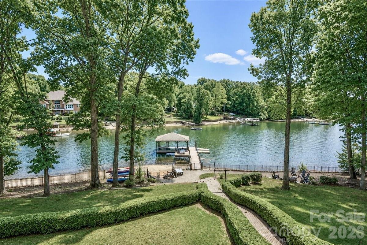 This exceptional Lake Norman waterfront investment property in Troutman, NC offers a rare opportunity to own a proven income-producing short-term rental with no HOA restrictions and the ability to continue operating as a vacation rental. With 4 bedrooms, 5 full baths, 1 half bath, and over 7,000 square feet, there is ample room for large groups and multiple families to gather while still enjoying privacy and space. In addition to the four bedrooms, the home features multiple flex rooms currently utilized as additional sleeping areas, allowing the property to comfortably accommodate up to 20 guests.

Designed with entertaining and guest comfort in mind, the home features two full kitchens, multiple living and recreation areas, and expansive gathering spaces throughout. A covered boat slip conveys with the property, providing direct access to Lake Norman, while nearby boat rental options allow guests to easily enjoy the water. Outdoor amenities include a lakeside firepit area, paddleboard and canoe storage, and plenty of room to relax and take in the waterfront setting.

Offered fully furnished and turnkey, the sale includes all furniture, bed and bath linens, kitchen appliances, cookware, utensils, and entertainment amenities including a foosball table, pool table, and ping pong table. Future scheduled tenant bookings will convey with the property, allowing the next owner to step into immediate rental income.

The home has been well maintained and includes numerous updates: five HVAC systems, with one AC unit replaced in July 2024 and a heat pump replaced in June 2023; septic pumped in August 2025; well replaced in 2020 (per previous owner); water heater replaced in 2020 (per previous seller); and two mattresses replaced in 2025. The roof is approximately 2010 (per previous owner).

Situated on approximately 0.8 acres, this unique Lake Norman property combines waterfront recreation, strong investment potential, and relaxed lake living. Whether you're seeking a vacation rental business, a second home, or a private retreat with room for everyone, this property delivers a rare blend of lifestyle and income opportunity.