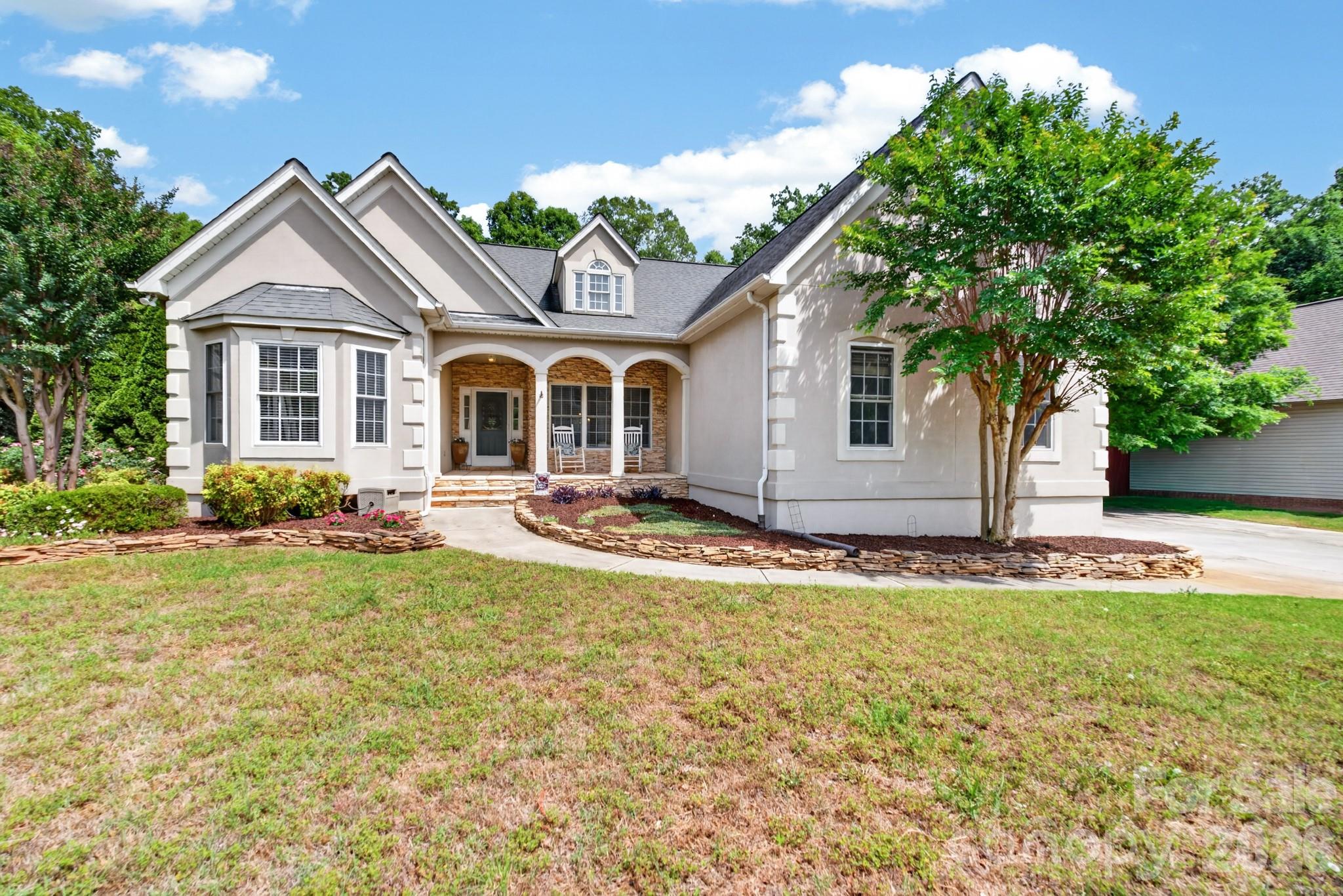 Welcome to 3527 Nestling Lane, located in the Quail Ridge neighborhood.  The quaint rocking chair front porch, with columns and stacked stone, will welcome you to this beautiful home with all three bedrooms on the main level.  The foyer invites guests in with columns and hardwood floors - leading to the cozy family room that features a corner gas fireplace.  Step up to the raised breakfast area and kitchen that provide an open concept plan.  Prepare your meals in the kitchen with stainless appliances (electric induction cooktop/range) and qranite countertops – serving them in the dining room with vaulted shaft ceiling - making it bright with so much natural light.  The primary bedroom provides fabulous space, including a private primary bath with tile shower and soaking tub.  In this split bedroom plan, two additional bedrooms share a full bath. Upstairs is quite impressive!  Walk up into a large bonus room and an adjacent flexible room that is currently used as a guest bedroom (no closet).  A full bath and an office are wonderful additions.  Let your imagination run wild in the incredible recreation/game room space that is filled with potential for so many uses.  This home is equipped with many custom built-ins throughout, including a drop zone that is both useful and beautiful.  The fenced-in and gated backyard is a great spot for outdoor entertaining - and a gated side yard is a welcomed bonus!   The wooded backdrop that provides both privacy and enjoyment of nature is such a rare find.  Enjoy a leisurely walk to the neighborhood green space, picnic area, and playground that is a short distance from the home.  Located close to Carowinds and uptown Charlotte, you need to come see all this home has to offer.