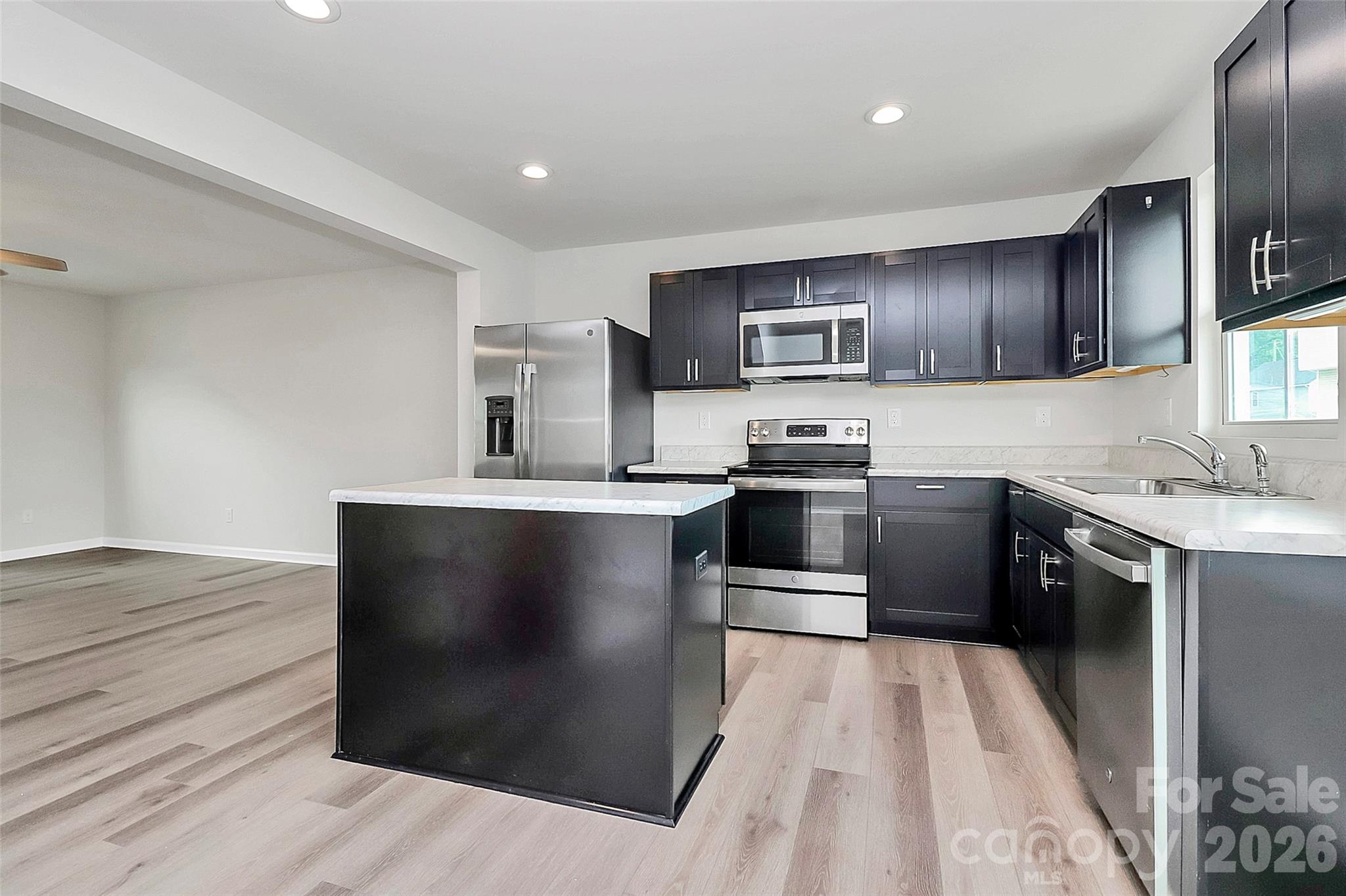 This three bed, two and a half bath residence is practically brand new and move in ready.  Easy on and off access to I-77, located minutes from shopping and dining and less than a 15-minute drive to B of A stadium, this gorgeous townhome offers all of the benefits Charlotte has to offer.  The entry way and garage open up to a well-designed lower floor office / study.  The open concept living space on the main floor combines functionality and style, blending the kitchen, dining and entertainment space, all in one.  The upstairs sleeping quarters provides and escape for privacy and comfortability.  The primary bathroom has been enhanced with modern wainscoting and the closet comes complete with built-in shelves for ideal storage. Whether you are downsizing for convenience or a first-time home buyer looking to begin their home ownership journey, this home is a must see and will be perfect for you!