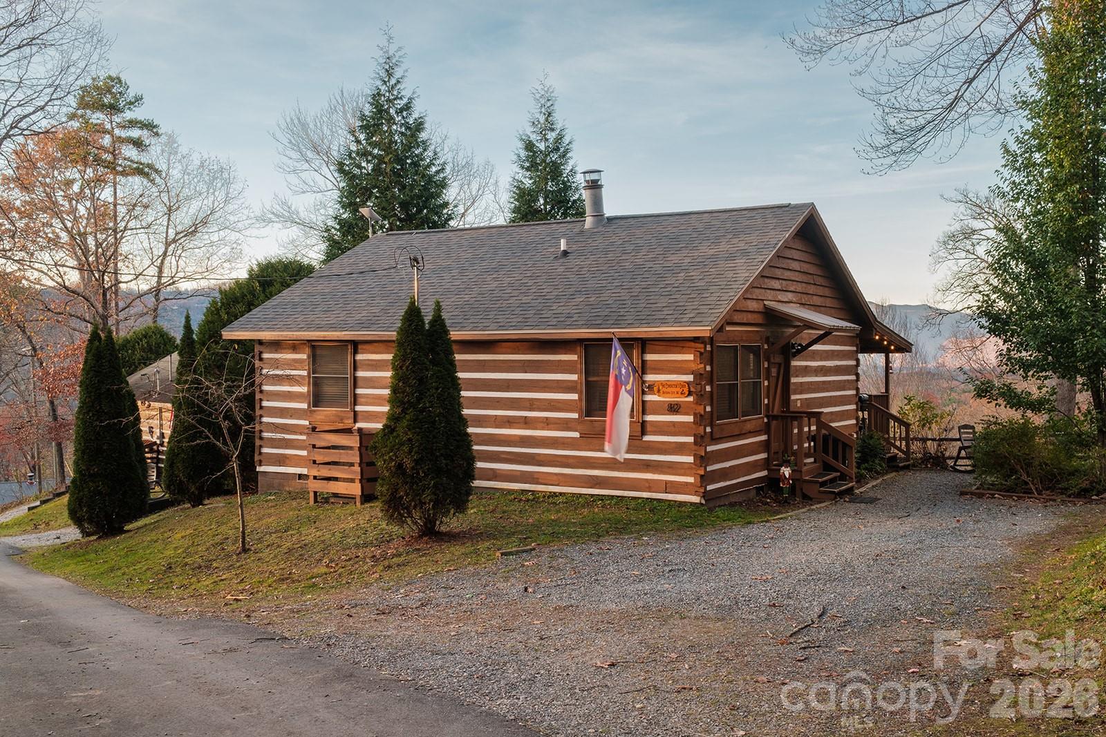 The perfect log cabin with a year round, long range view that checks every single box. Being sold fully furnished with everything you or a guest could possibly need to have an amazing stay. Including extremely fast Starlink internet to stream and stay connected. Year round views of the Smoky Mountains from inside the Nantahala National Forest. It has a firepit, a mountain view-facing covered porch with a hot tub, wood burning fireplace, a full size kitchen, wood-burning fireplace, and 2 comfortable bedrooms and a recently renovated full size bathroom. This has been the #1 performing 2-bedroom log cabin in Bryson City on Airbnb for 3 of the last 4 years. Perfect getaway, 1031 exchange, and/or cost-segregation candidate property that performs all year long. All major upgrades have happened in the last 7 years- including HVAC (Lennox central heat and air) that was replaced in 2019, a new architectural roof in 2020, all new furniture in 2023, new hot tub in 2024, bathroom remodel in 2025, and new appliances in 2026 (except fridge). There are so many touches to this cabin that have been thought of and improved, it's impossible to list here. Call for more details and questions, the property is owned by the listing agent. 
7 minutes to the Nantahala Outdoor Center. 
5 minutes to Lake Fontana. 
12 minutes to Bryson City/Ingles. 
15 minutes to Deep Creek entrance to Great Smoky Mountain National Park. 
25 minutes to Harrah's Cherokee Casino.