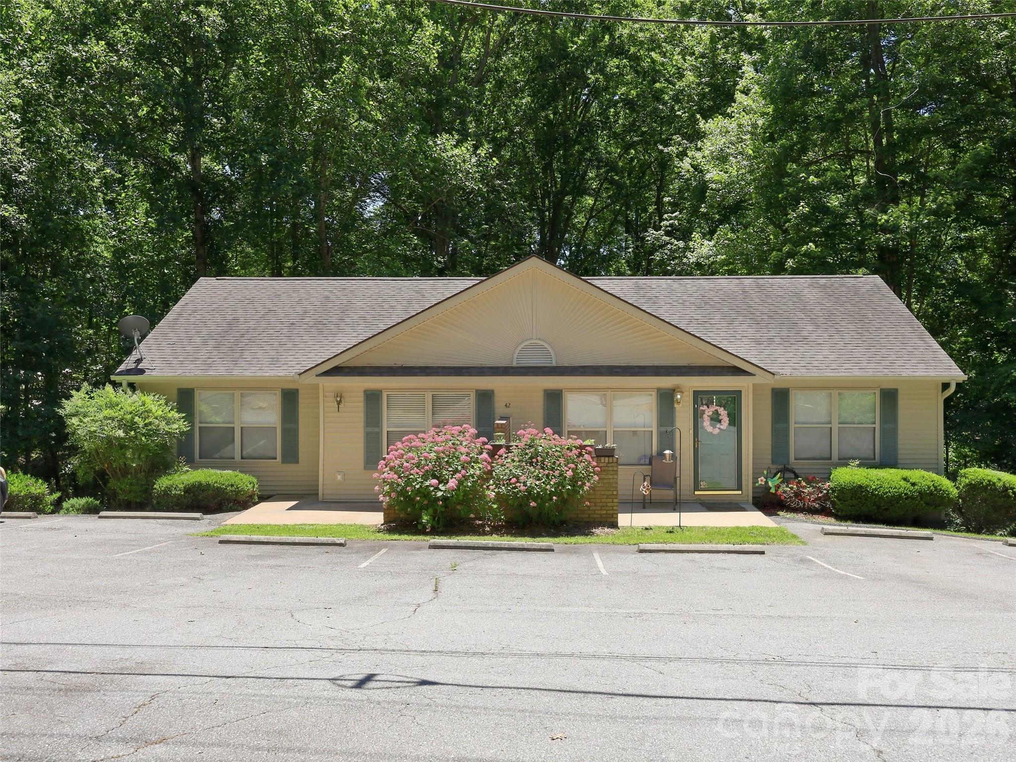 Welcome home to this beautiful, low-maintenance condo in the desirable Woodland Trails community! Perfectly positioned for an easy commute to Asheville, this 2-bed, 2-bath ground-floor unit offers true one-level living with no interior steps. The bright living room features a cozy fireplace and flows seamlessly into the dining and kitchen areas—perfect for entertaining. Spacious primary bedroom featuring a private ensuite bathroom. Zero yard work, private patio, main-level utility/laundry room, and low-maintenance laminate flooring. Close to local Enka/Candler amenities, shopping, and outdoor recreation, while tucked away from the hustle and bustle. Ideal for first-time buyers, downsizers, or anyone looking for a lock-and-go mountain lifestyle. Schedule your showing today!