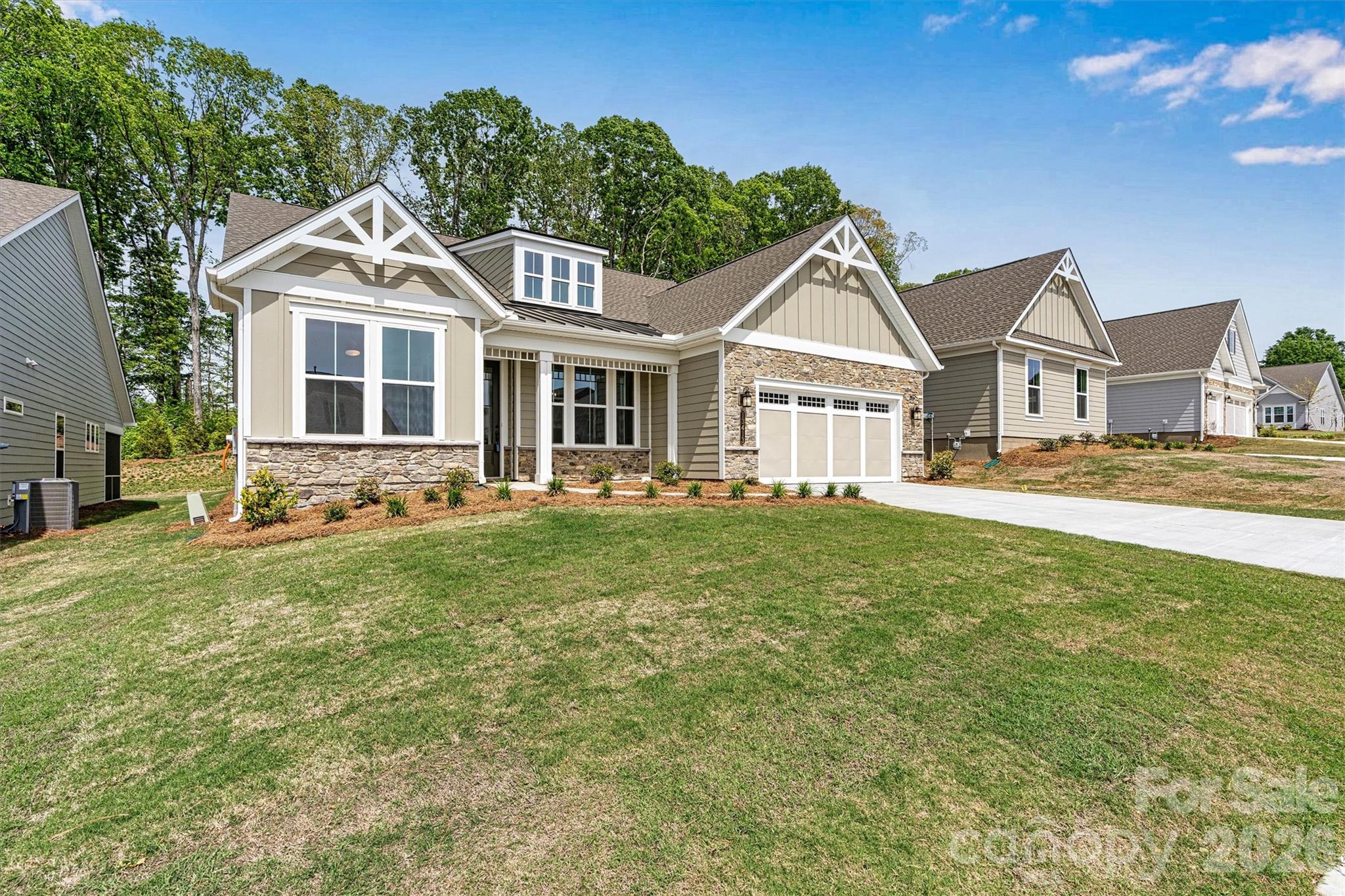 **NEW CONSTRUCTION** Welcome to the REDWOOD, a beautifully designed 3 bed-2.5 bath home filled with natural light, open spaces, and timeless Southern charm. Thoughtfully crafted with designer finishes throughout, this home offers both elegance and everyday comfort. The spacious Primary Suite features tray ceiling, TWO CLOSETS and a spa-inspired bath with quartz countertops, undermount rectangular sinks, frameless shower doors, a no-barrier tile shower floor, comfort-height soft-close toilet, and a hand-held shower head. An impressive coffered ceiling and gas fireplace in the Great Room add character, while expansive windows and double French doors in the Library bring in abundant natural light. Ceiling fans in the Great Room, Library, Primary Suite, and screened porch keep every space comfortable. The gourmet Kitchen is perfect for entertaining with quartz counters, tile backsplash, GE stainless appliances, gas cooktop with vented hood, built-in oven and microwave, soft-close drawers, pull-out base cabinets, under-cabinet lighting, and a convenient Butler’s pantry. Luxury EVP flooring flows through the main living areas and Primary Suite for a seamless, upscale look. Enjoy outdoor living on the extended 8' screened porch. Additional highlights include a 4' garage extension with light attic storage above (pull-down stairs), a 4-lite glass exterior door, and LED lighting throughout. Upgraded paint, refined designer touches, and thoughtful details create a home that feels bright, open, and effortlessly elegant.