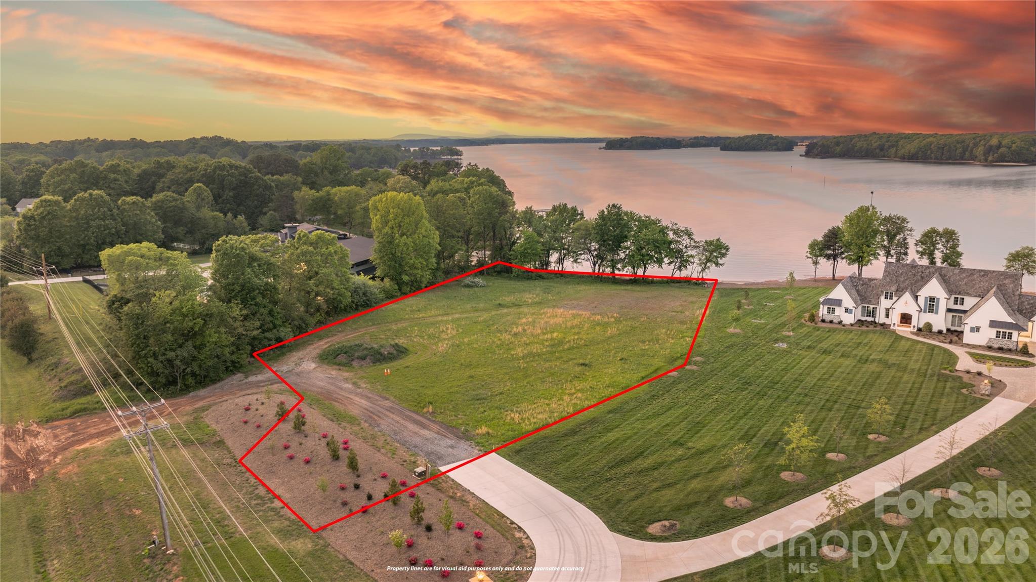 One of the last most distinguished waterfront lots of this size still available on Lake Norman’s southern shore. Rarely does an opportunity like this come along. This extraordinary 1.94-acre waterfront lot offers 234 feet of prime shoreline and sweeping big-water views across the open lake. Imagine waking up to breathtaking sunrise views over the water, as the sun rises in the east, casting a golden glow and illuminating the calm lake surface. The home is flooded with warm natural light from the very first light of day. Located on the quieter southern stretch, this serene area enjoys significantly less boat traffic, letting you truly relax and enjoy peaceful waterfront living with close proximity to the city. Enjoy your own naturally occurring sandy beach right on the property — no sand delivery necessary. Positioned between two distinguished estate homes, this large, flat, build-ready lot with prime accessibility is ready for its new owner. It presents a private canvas — perfect for creating your dream waterfront estate on one of Lake Norman’s most coveted stretches. Enjoy the ultimate Lake Norman lifestyle directly from the shoreline while staying seamlessly connected to modern conveniences: upscale shopping and dining at Birkdale Village, the waterfront charm of Cornelius, the attractions of Mooresville, and the energy of Uptown Charlotte are all easily reachable. This prime south shore location delivers the perfect balance of peaceful open-water living and convenient access to the city, airport, and vibrant Lake Norman communities.