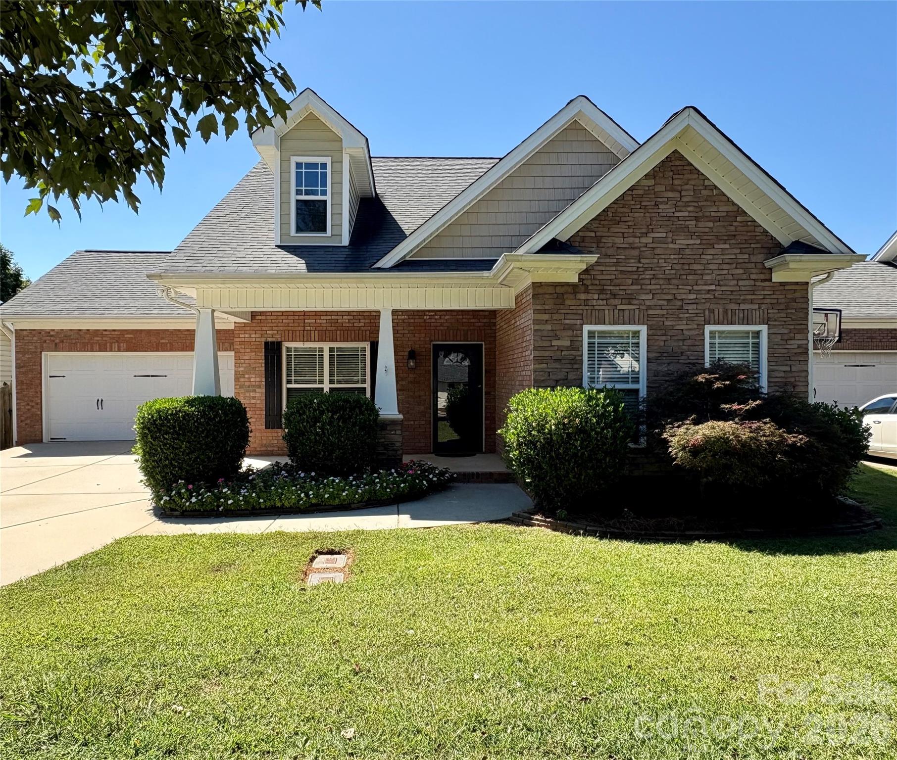 Convenient to Charlotte, Concord or Monroe but country living at its finest! Tucked away on one of Locust's most peaceful, tree-lined streets, this one-of-a-kind gem offers more than just a place for your family to live...it is a classic Carolina lifestyle! Church Street has a welcoming Hallmark movie feel to it. As you step up to the covered front porch encased with custom detail, a feeling of relaxation is immediate. Plenty of room for rocking chairs! There is a calm of country charm fused with modern comforts. Fireplace in great room is visible from the front door,
split bedroom plan offers primary ensuite privacy. New paint and carpet, spacious kitchen with eat-in bar, granite counter tops, custom cabinets, and many other amenities that make this kitchen a chef's dream! Private ensuite lovely views of backyard. Large vanity, sep shower and tub, walk in closet, and more. Covered porch in back, enclosed, fenced back yard is ready for your pets! Nice two car garage. Character throughout! Doll house!