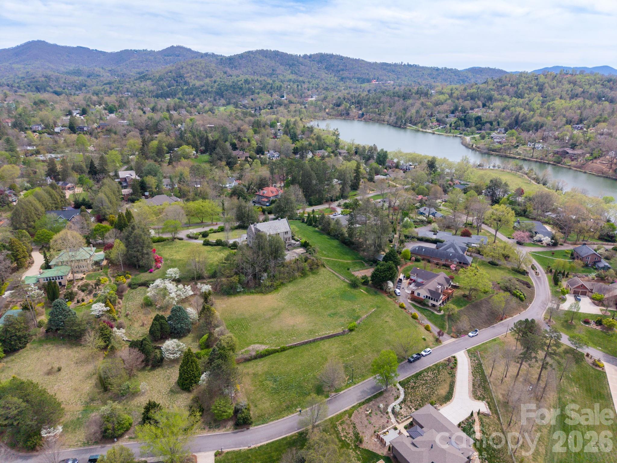 Wonderful building opportunity in a prime North Asheville location with wonderful long- and short-range mountain views. This rare homesite in The Midlands offers the perfect blend of convenience, setting, and mountain views—without the challenge of a steep drive.  The cleared, gently positioned 1.26 acre combined lot is ideal for construction, making it ready for your vision. Enjoy unobstructed mountain views and a beautiful natural backdrop that creates an inviting setting for a custom home. Located just steps from Beaver Lake and its scenic walking trail, the Asheville Country Club, the Public Library, and Fresh Market, this property also provides quick access to all the dining, shopping, and culture of downtown Asheville. Set adjacent to Lakeview Park—one of Asheville’s most walkable and desirable areas—this is a rare chance to build your dream home in a truly exceptional location.