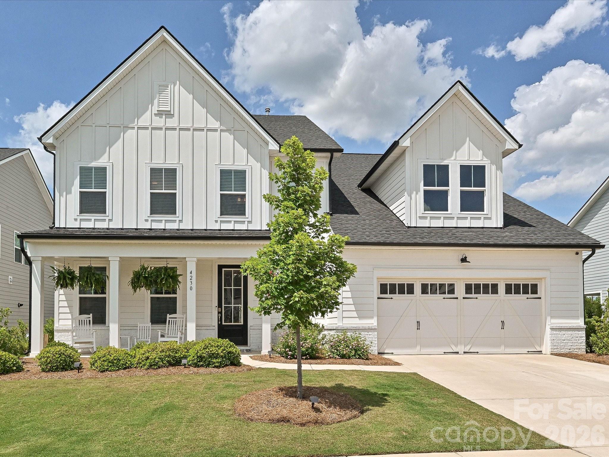 Stunning modern farmhouse just minutes from Ballantyne! This exceptional 5-bedroom, 4.5-bath home blends timeless design with luxurious modern finishes throughout. The bright white chef’s kitchen features quartz countertops, designer tile, farmhouse sink, double ovens, gas cooktop and stainless-steel hood and an impressive white oak center island perfect for gathering and entertaining. The main level offers a beautifully designed color-drenched office with custom built-in desk space, along with a private guest suite and bath. Upstairs, the luxurious primary retreat features a cozy fireplace and spa-inspired bath complete with soaking tub and striking black quartz countertops. A spacious loft provides flexible living space for media, play, or relaxation. Custom millwork and designer lighting throughout the home adds warmth and sophistication, while the covered back porch overlooks a fenced backyard with gorgeous landscaping and some spectacular sunsets! Additional highlights include a 3-car tandem garage with work sink, gas line for grill and an unbeatable location close to shopping, dining, and everything Ballantyne has to offer.