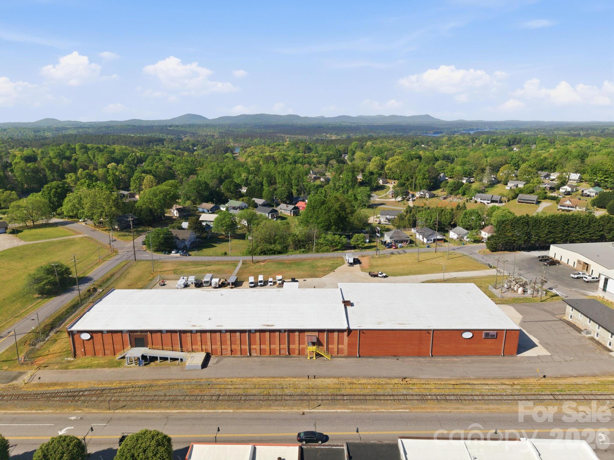 Exceptional industrial/commercial opportunity in the heart of downtown Granite Falls! Situated on 4.6 acres, this expansive property offers approximately 64,161 total square feet, including 30,120 SF on the main level, 32,078 SF on the lower level, plus 1,963 SF of office space. Features include a loading dock, ample warehouse/storage space, and a versatile layout ideal for manufacturing, distribution, storage, or redevelopment. Prime location with easy access to Hwy 321 provides excellent connectivity for logistics and business operations.

Flexible purchase options available: Purchase for $3,300,000 and current owners will execute a 3-year leaseback with a 2-year renewal option, providing immediate income potential. Alternatively, purchase for $2,800,000 and current owners will vacate within 60 days of closing. Rare owner-user or investment opportunity with flexible terms.