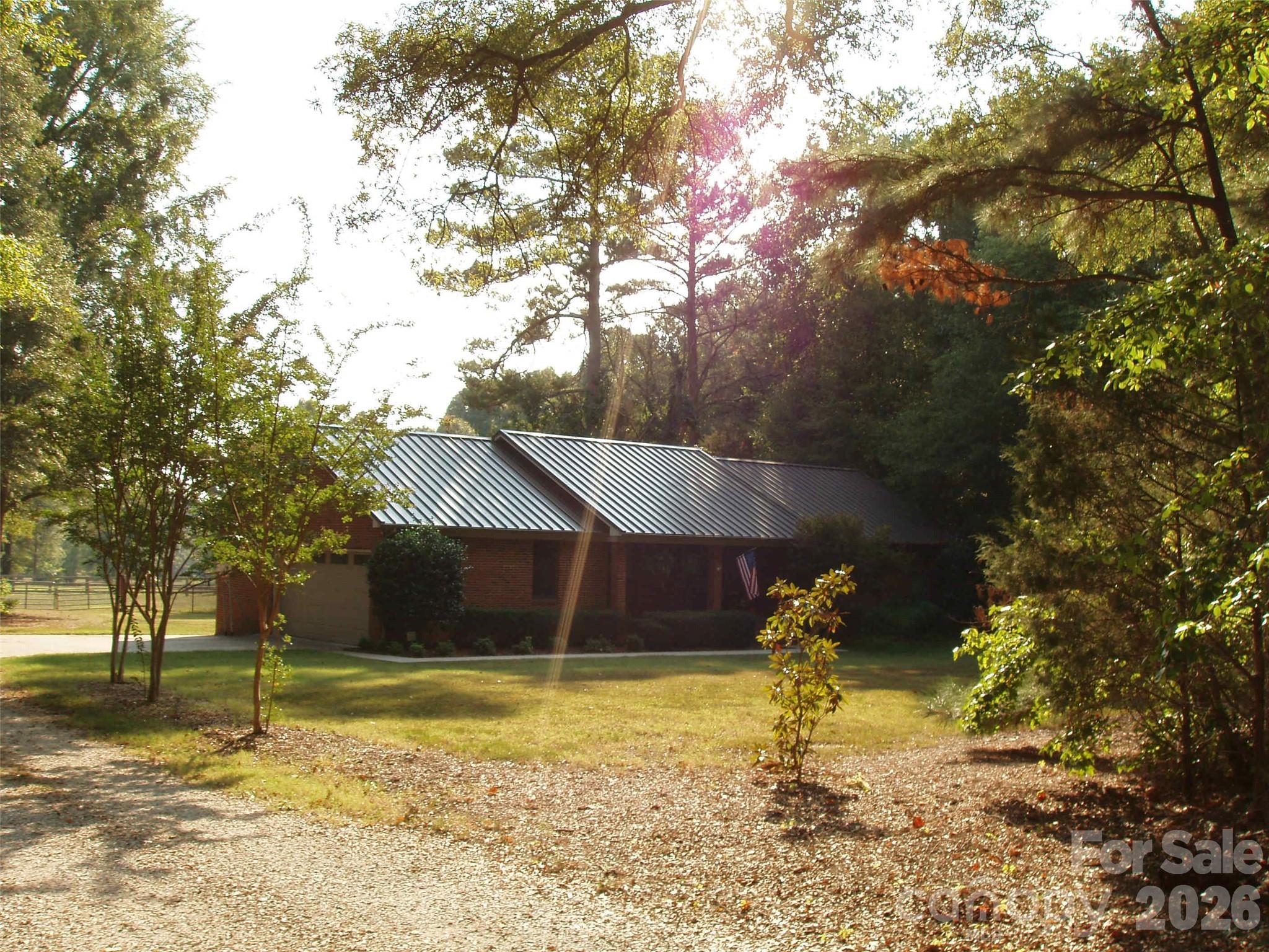 Beautiful brick home in excellent condition on 19 +/- acres mainly pasture with a shared pond and fencing in place.
Three bedroom two full bath home with two car attached garage.  Covered pavilion with firepit, fenced back yard and fencing around most of the pasture area. Two bay run-in shed for horses or livestock. Rural setting in York County Located southwest of Rock Hill approximately 7.5 miles from Piedmont Medical Hospital and 11.6 miles to I-77 & Hwy. 21 / Cherry Rd exit.