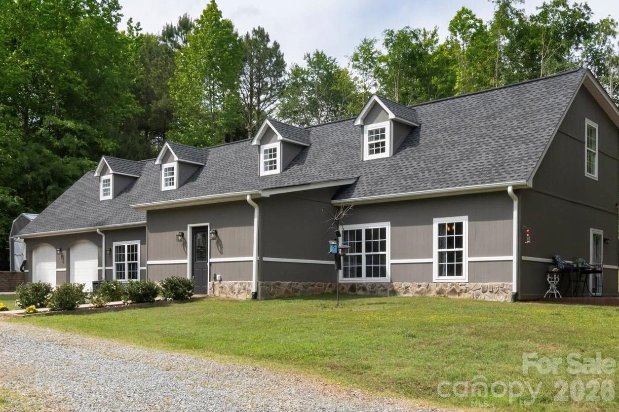 Conveniently located five minutes from Landrum SC, this well-appointed Polk County NC residence offers the finest of building materials and full-acre secluded, level lot. Resilient tile floors lead the way from the sizable dining room to the immense, updated kitchen.  Hickory wood floors and nine foot ceilings adorn the expansive, open-concept living room area.  The owner's suite is massive, with a vast walk-in closet, a private balcony that leads to the back yard, and gorgeous birch wood floors.  The huge primary bathroom is exactly what you expect--tile floors, shower and bath tub,  plus updated fixtures and vanity.

Attention dog lovers!  The backyard is fenced and the doggy door leads to the climate controlled garage which can be used as Puppy World or auto shop.
Attention grill masters!  The kitchen-adjacent patio is the epitome of outdoor cooking, entertaining, or just relaxing.
Attention movie buffs!  Whether you're into Top Gun or Legally Blonde, the home theater takes movie night to a whole new level for friends and family.
Seller has already had multiple inspections performed and these are available to buyers.
This home is so close to so many things:
5 minutes to Ingles, Starbucks, Aldi, hardware store.
15 minutes to Tryon International Equestrian Center.
25 minutes to Spartanburg.
30 minutes to downtown Hendersonville NC.
Three international airports with 85 minutes.             Restaurants within 15 minutes include Thai, Cajun, Sushi, Italian, Southern, BBQ, Mexican, Diner, and much much more!