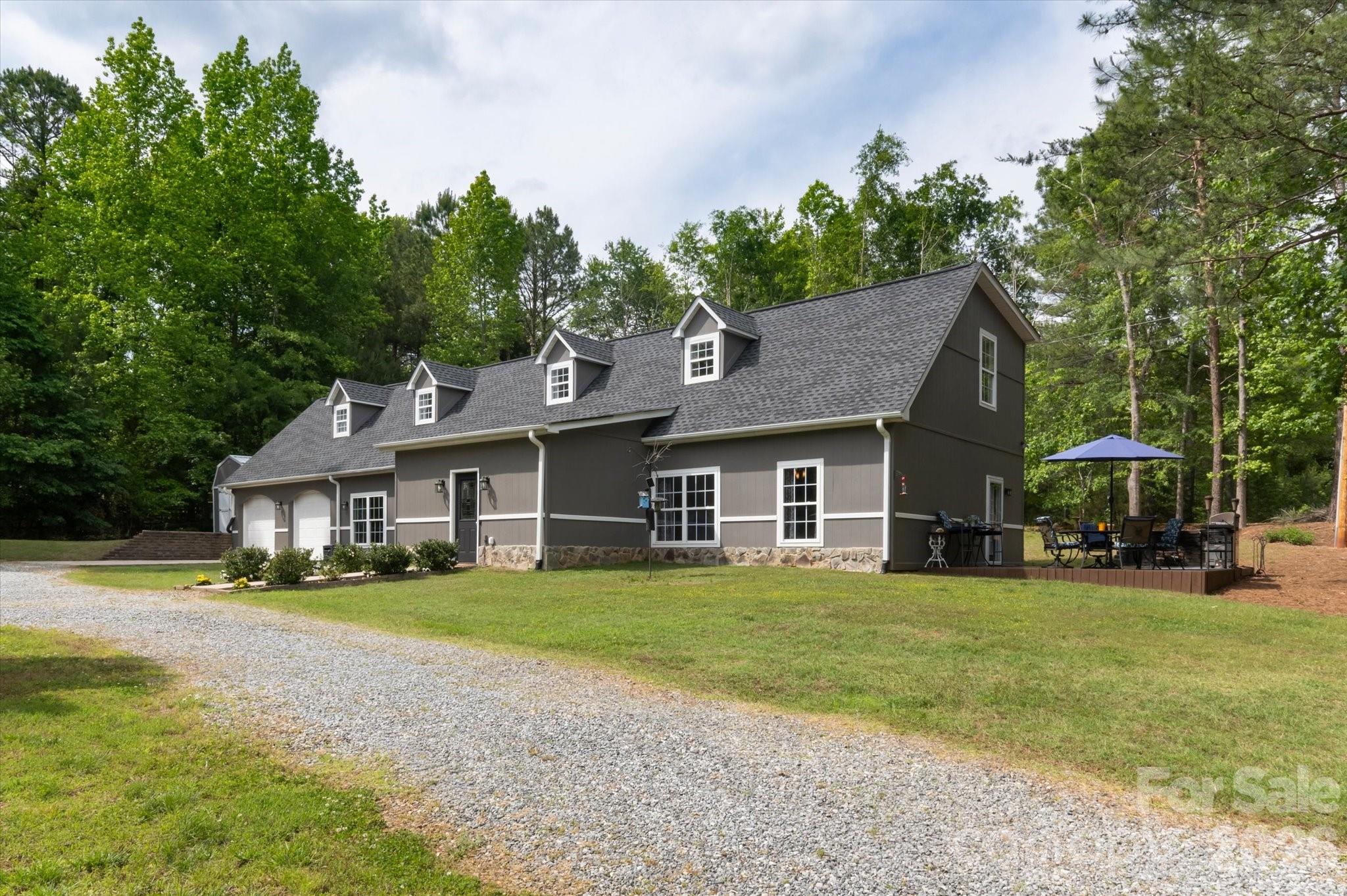 Conveniently located five minutes from Landrum SC, this well-appointed Polk County NC residence offers the finest of building materials and full-acre secluded, level lot. Resilient tile floors lead the way from the sizable dining room to the immense, updated kitchen.  Hickory wood floors and nine foot ceilings adorn the expansive, open-concept living room area.  The owner's suite is massive, with a vast walk-in closet, a private balcony that leads to the back yard, and gorgeous birch wood floors.  The huge primary bathroom is exactly what you expect--tile floors, shower and bath tub,  plus updated fixtures and vanity.

Attention dog lovers!  The backyard is fenced and the doggy door leads to the climate controlled garage which can be used as Puppy World or auto shop.
Attention grill masters!  The kitchen-adjacent patio is the epitome of outdoor cooking, entertaining, or just relaxing.
Attention movie buffs!  Whether you're into Top Gun or Legally Blonde, the home theater takes movie night to a whole new level for friends and family.

This home is so close to so many things:
5 minutes to Ingles, Starbucks, Aldi, hardware store.
15 minutes to Tryon International Equestrian Center
25 minutes to Spartanburg
30 minutes to downtown Hendersonville NC
Three international airports with 85 minutes