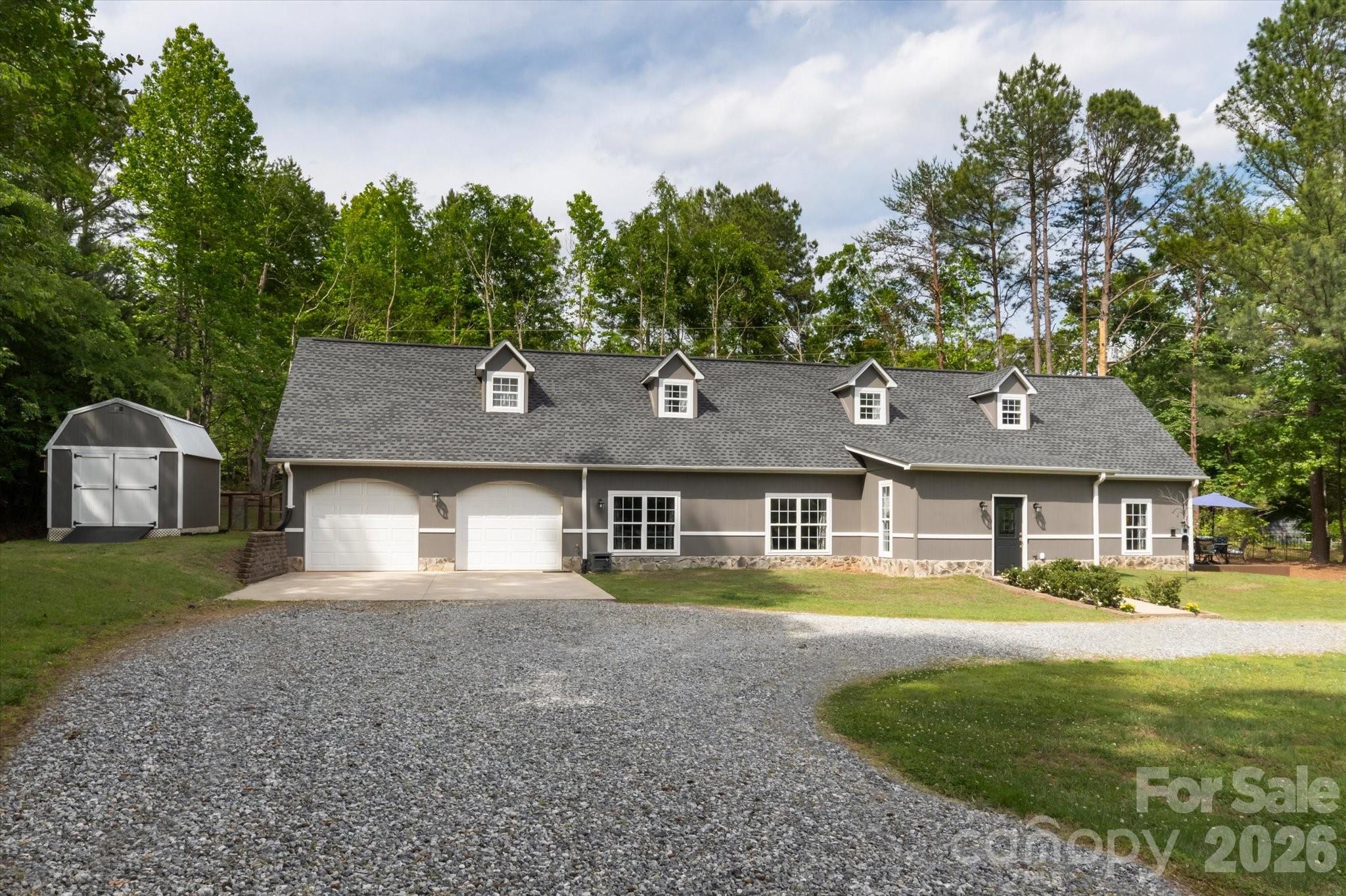 Conveniently located five minutes from Landrum SC, this well-appointed Polk County NC residence offers the finest of building materials and full-acre secluded, level lot. Resilient tile floors lead the way from the sizable dining room to the immense, updated kitchen.  Hickory wood floors and nine foot ceilings adorn the expansive, open-concept living room area.  The owner's suite is massive, with a vast walk-in closet, a private balcony that leads to the back yard, and gorgeous birch wood floors.  The huge primary bathroom is exactly what you expect--tile floors, shower and bath tub,  plus updated fixtures and vanity.

Attention dog lovers!  The backyard is fenced and the doggy door leads to the climate controlled garage which can be used as Puppy World or auto shop.
Attention grill masters!  The kitchen-adjacent patio is the epitome of outdoor cooking, entertaining, or just relaxing.
Attention movie buffs!  Whether you're into Top Gun or Legally Blonde, the home theater takes movie night to a whole new level for friends and family.

This home is so close to so many things:
5 minutes to Ingles, Starbucks, Aldi, hardware store.
15 minutes to Tryon International Equestrian Center
25 minutes to Spartanburg
30 minutes to downtown Hendersonville NC
Three international airports with 85 minutes