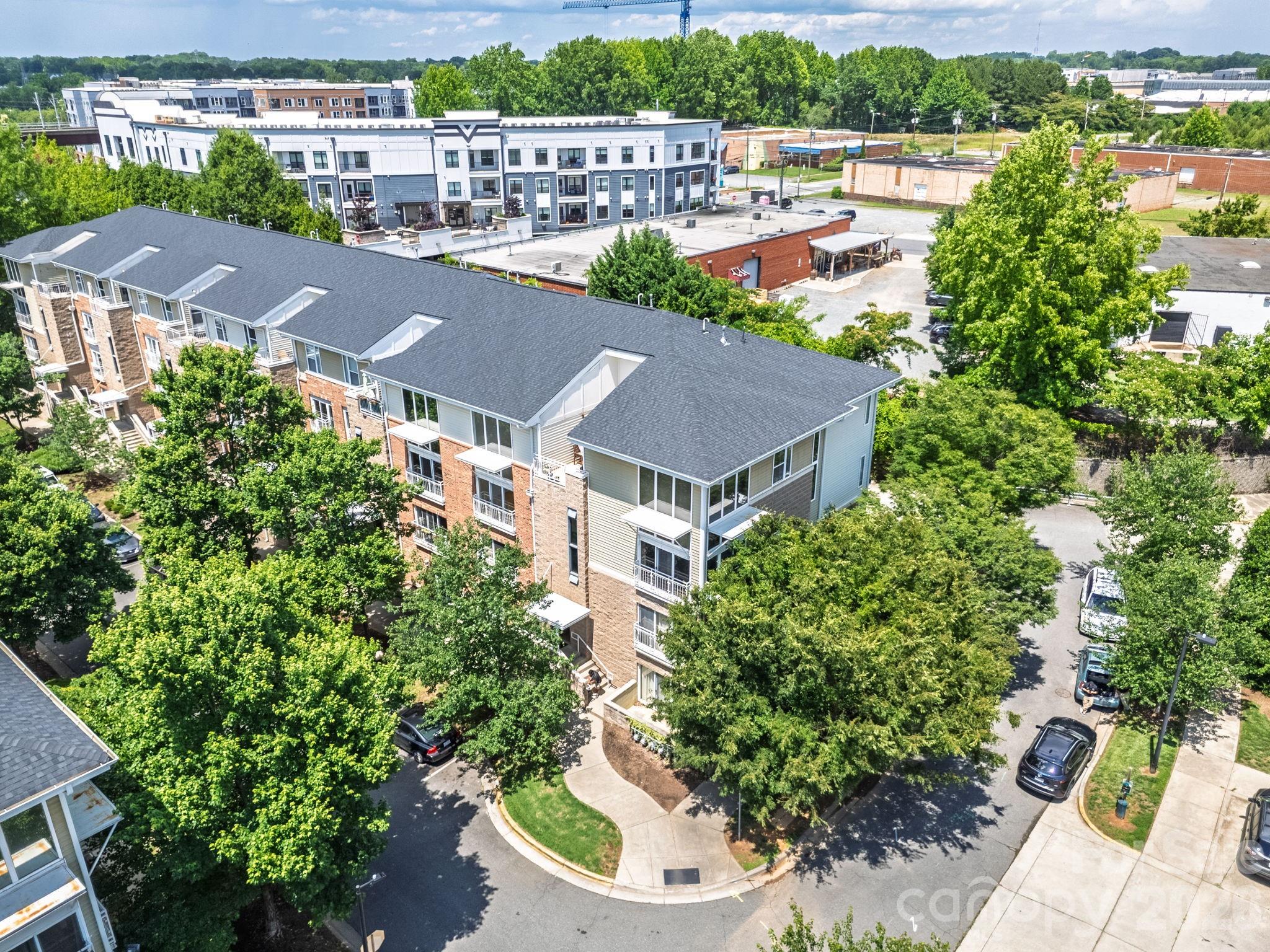 Welcome home to NoDa! This urban loft style 3-bedroom, 2.5-bath condo in the highly sought-after Renaissance community blends modern comfort with vibrant urban living. Step inside and you'll immediately notice the abundance of natural light pouring through the space, highlighting the open concept where you'll see freshly painted interiors from floor to ceiling. The main level features engineered hardwood flooring, while the upper level showcases warm cozy carpet for a clean, contemporary feel. The dramatic two-story great room creates an airy, loft-inspired atmosphere and features a Juliet balcony that overlooks the tree lined streetscape. The kitchen is designed for both everyday living and entertaining, complete with a breakfast bar, stainless steel appliances, granite countertops and a spacious pantry. A main-level primary suite adds convenience and flexibility, featuring a large walk-in closet and an ensuite bath with a dual sink vanity. A dedicated full-size laundry room is also located on the main floor adjacent to the kitchen. Head Upstairs & you'll find two spacious bedrooms, a full bath, and the open loft perfect for a home office, creative studio, or lounge space. Plenty of storage in downstairs coat closet, loft closet and the 1 car garage.Monthly HOA dues include water, sewer, and trash service, making for easy, low-maintenance living in one of Charlotte's most dynamic neighborhoods. Live where Charlotte comes alive in NoDa's vibrant arts district, you're just steps from iconic hotspots like Neighborhood Theatre, Smelly Cat Cafe, Ever Andalo, Haberdish as well as the neighborhood's renowned breweries, galleries, and nightlife. With the CATS LYNX Blue line light rail stop at 36th street: Uptown, NC Music Factory, Optimist Hall, Panthers Stadium and the city's best destinations are always within reach. Come see for yourself today!