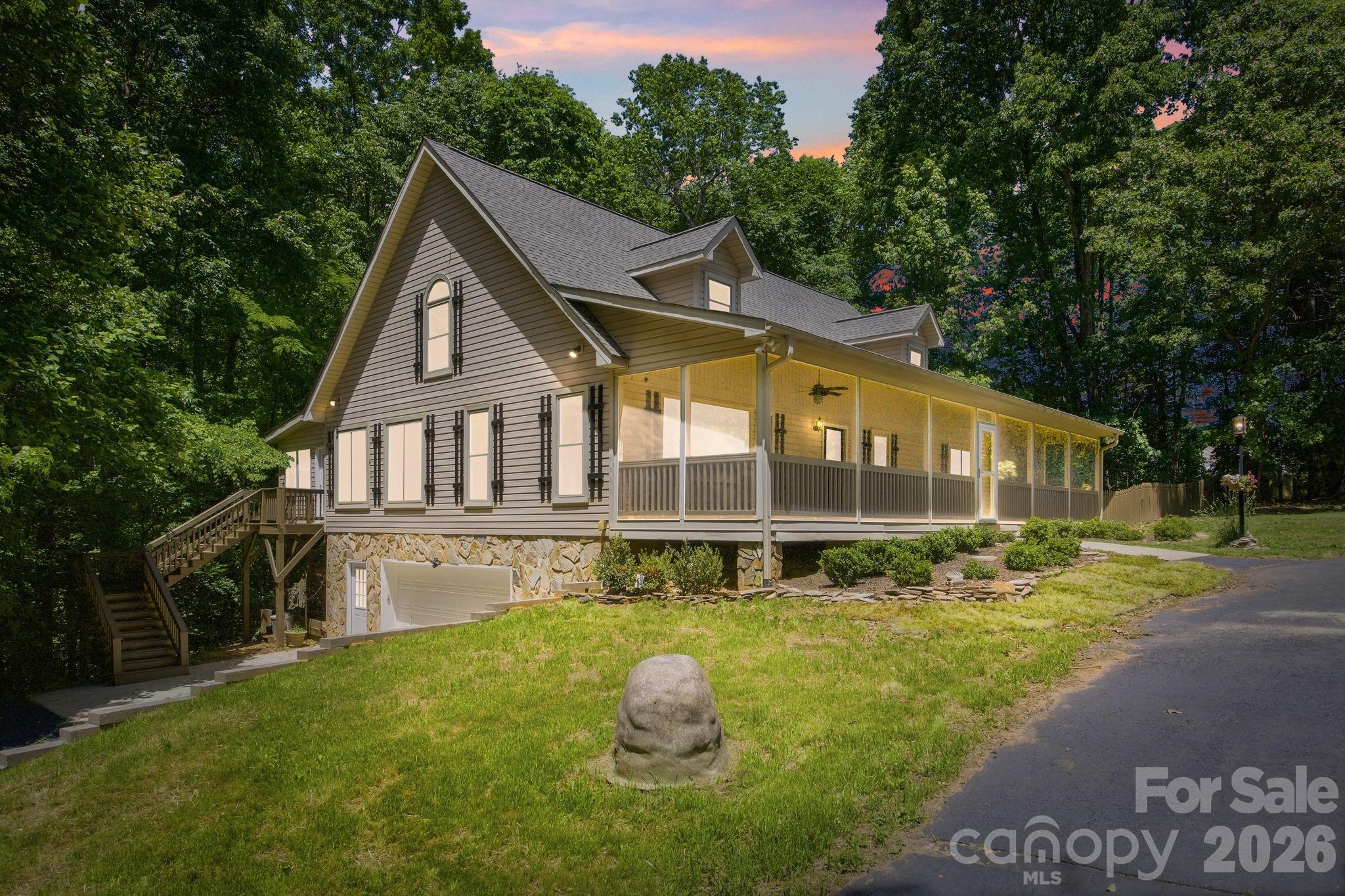 Farmhouse serenity close to town. This extraordinary offering includes two parcels totaling approximately 18.5 private acres, creating a rare opportunity to own a secluded estate just minutes from the vibrant heart of Mooresville. Located only five minutes from downtown dining, shopping, and entertainment, 195 Azalea Road delivers the perfect balance of convenience, privacy, and natural beauty.
As you enter through the gated entrance, a winding tree-lined driveway sets the tone for this peaceful retreat tucked away among mature hardwoods and rolling landscape. The setting feels worlds away while still being close to everything Mooresville has to offer. Surrounded by nature, the home is thoughtfully positioned to capture breathtaking wooded views, open green spaces, flourishing wildlife and the tranquil sounds of a nearby year-round waterfall. 
Designed for those who appreciate indoor-outdoor living, the property offers an incredible variety of spaces to relax and entertain. The expansive screened front porch stretches across the full width of the home, creating the perfect place to enjoy morning coffee, evening sunsets, or peaceful afternoons surrounded by nature. Multiple outdoor living areas include a spacious covered rear porch, side deck, and additional gathering spaces that seamlessly connect the home to its serene surroundings. Two car garage with fresh epoxied floor.
Inside, oversized windows flood the home with natural light and frame stunning views from nearly every room. A spectacular sunroom serves as the centerpiece of the home, offering panoramic views of the trees while creating a peaceful year-round escape. The thoughtfully updated interior features new LVP flooring, fresh paint, and modern finishes throughout, blending warmth and comfort with contemporary style.
The beautifully renovated kitchen has been redesigned with sleek cabinetry, updated granite countertops, stylish fixtures, and modern appliances, offering both elegance and functionality for everyday living and entertaining. The spacious primary suite and updated bath provide a luxurious retreat feel, while the flexible floor plan offers four bedrooms with room for guests, home offices or recreation spaces.
Beyond the home itself, the property opens up to endless possibilities. A second drive branches off the main entrance and leads to two expansive cleared fields surrounded by woods, ideal for horses, recreation, gardening, additional homesite or simply enjoying wide-open privacy. The poultry barn and multiple outbuildings provide abundant storage and flexibility for equipment, hobbies or workshop.
With two separate parcels included, the property presents a unique opportunity for a family compound, private retreat, multigenerational estate, or investment opportunity. There is potential to build a second home along with up to two guest houses, creating exceptional flexibility rarely found this close to downtown Mooresville.
Whether you are searching for a full-time residence, weekend escape, equestrian property, or private estate with room to grow, 195 Azalea Road offers an unmatched combination of acreage, peace, modern updates, and development potential. Permit on file for a 54 x 35 barn, land has been prepared for foundation. Permitted Sunroom was added in 2008. New roof in 2026. Kitchen, floors and paint update 2025. New windows 2024. Electric cooktop can be converted back to gas, hookup still present.  Present barn is a licensed NC regulated hatchery. No Septic permit on file (tax records indicate 4 bedroom), tank and lines and were located, and new perc test on file for future building on second lot. Driveway was resurfaced in 2026. 
Experience the perfect blend of nature, privacy, luxury, and opportunity — a truly one-of-a-kind property where your next chapter begins. Gated, Appointment Required, no drive-bys.