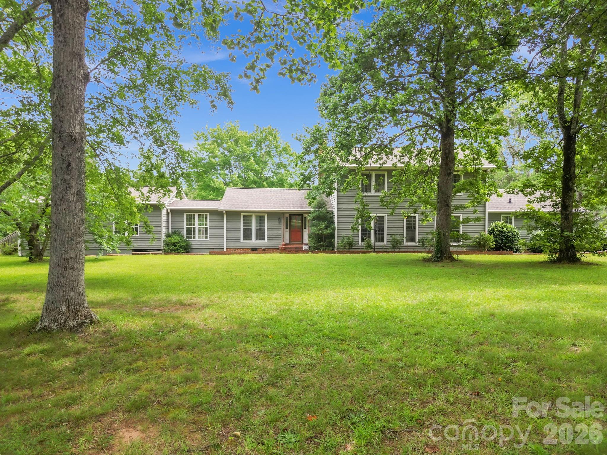 Rare opportunity in the highly sought-after Gowensville area, ideally positioned near the intersection of Highway 11 and Highway 14, one of the Upstate's most desirable rural luxury corridors. Surrounded by pristine horse farms, mountain views, and distinguished newer homes, this 5.3-acre property offers a unique combination of privacy, flexibility, and country elegance with no deed restrictions.

Set well back from the road and bordered by trees on both sides, the home enjoys exceptional privacy while showcasing mostly level, open land that backs to a peaceful pond with its own dock. The acreage is ideal for equestrian pursuits, a hobby farm, gardens, or simply enjoying wide-open space in an exclusive countryside setting.

The home features soaring two-story ceilings in the living room, a loft overlooking the main living area with built-in cabinetry, and a bright sunroom accented by exposed beams and bleached pine walls and ceilings. The kitchen flows seamlessly into the dining area, while the conveniently located powder room/laundry room provides easy access for guests.

The primary suite offers a walk-in closet, dual vanities, and a zero-entry tile shower. Adjoining the suite is a spacious year-round flex room currently housing a swim spa, surrounded by windows that fill the space with natural light. Upstairs are two generously sized bedrooms connected by a Jack-and-Jill bath, along with a loft area ideal for a home office, library, or reading retreat.

Outdoor living is enhanced by multiple decks overlooking the scenic grounds, where deer are frequent visitors and mature dogwood, Japanese maple, mimosa, maple, crape myrtle, and white oak trees provide beauty throughout the seasons.

A rare and valuable feature is the combination of an attached two-car garage plus an oversized detached two-car garage with power and workbench, providing abundant space for vehicles, equipment, hobbies, or farm-related needs.

Recent improvements include a roof (approximately 6 years old), hypoallergenic insulation (2025), crawlspace encapsulation (2025), freestanding gas fireplace (2025), new ductwork (2026), some replacement windows, and a termite bond already in place. Natural gas service provides efficient heating and a tankless water heater.

Enjoy the best of Gowensville living—peaceful, private, and surrounded by some of the area's most beautiful equestrian estates and countryside views, yet conveniently located for access to Landrum, Tryon, Greer, and Greenville.
