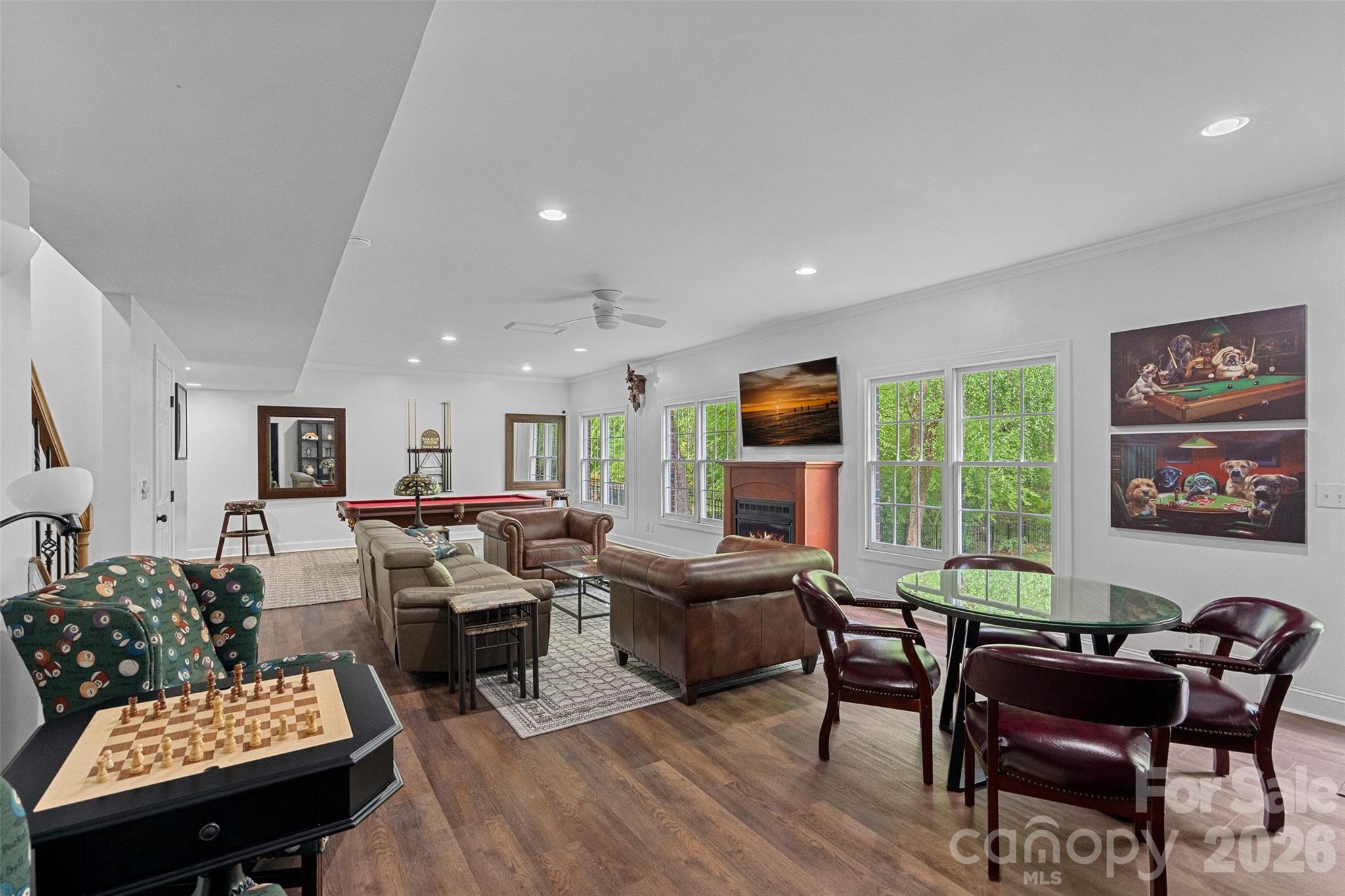 Tucked within the highly sought-after Hamptons neighborhood, this exceptional full-brick basement home blends timeless elegance with thoughtful, high-end updates—offering a rare opportunity in one of the area’s most desirable communities. From the moment you arrive, the home’s stately presence and beautiful landscaping sets the tone for what lies beyond. Inside, you’ll find beautifully updated flooring throughout and custom cabinetry that elevates the living spaces with both style and function. The kitchen has been completely reimagined from the studs—featuring all-new cabinetry, premium appliances, stylish lighting, beautiful backsplash and an appliance closet! Enjoy relaxing in your spacious living room by the fireplace or sitting in your very own wine room to take it easy after a long day. Upstairs, the primary suite is a true sanctuary—generously sized and thoughtfully designed with its own coffee bar for slow, luxurious mornings, along with additional flex space ideal for a home office or private fitness area. The fully renovated primary bath offers spa-like indulgence, complete with dual commodes for added comfort and convenience. Each secondary bedroom is equally well-appointed with its own private bath, ensuring privacy and comfort for all. The main living areas are complemented by a versatile basement level, complete with a kitchen, full bath and a bedroom that can easily serve as a guest suite or mother in law suite. Enjoy lounging in your spacious basement living room or enjoy a nice game of pool! The possibilities are endless! The basement also has a dedicated workshop which provides the perfect space for hobbies, yard equipment or weekend projects. Adding even more value and versatility, the finished upper floor offers endless possibilities—whether you envision a media room, playroom, bonus space, or simply abundant storage. Designed for both everyday living and effortless entertaining, the home offers a spacious screened porch overlooking a lush, private backyard that backs to a peaceful creek—creating a serene retreat right at home. The fully irrigated front and back yards ensure the landscape remains vibrant year-round; updated wrought iron fencing surrounds all sides of your yard. Additional highlights include two 50-gallon water heaters installed in 2022, ensuring efficiency and reliability for years to come. Perfectly positioned near top-rated schools, shopping, dining, Lake Norman, major highways, and Uptown, this home offers the ideal combination of luxury, location, and lifestyle. A rare basement home in this community with every detail considered—this is the one you’ve been waiting for. Welcome Home!