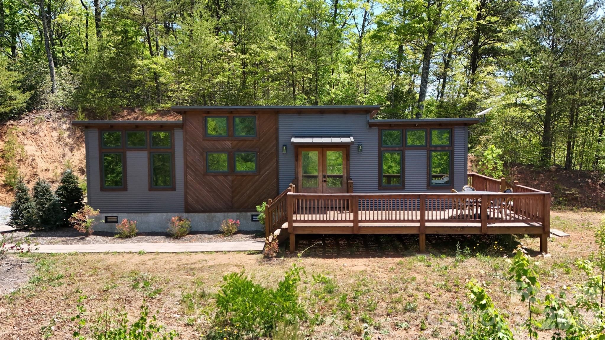 A property that offers what buyers search years to find: usable mountain land, privacy, views, and infrastructure already complete.



Tucked at the end of a quiet road just minutes from U.S. Route 441, this remarkable 4.77-acre property unfolds into three large, flat, dividable mountain parcels — an uncommon find in Western North Carolina, especially with infrastructure already in place.



Here, mornings begin with layered mountain light, evenings end under extraordinary star-filled skies, and every part of the land invites a different vision: a private retreat, a compound, additional homes, or an investment with rare built-in readiness.



A thoughtfully designed tiny home anchors the property, featuring a first-floor office/flex space, loft sleeping area, and matching custom storage shed — all positioned to take in the surrounding views. Native oak, poplar, pine, azalea, rhododendron, and dogwood frame the property naturally, creating beauty in every season.


What makes this property especially compelling is that so much of the groundwork is already complete:

• Private well

• Underground electric

• Three installed septic systems

• High-speed WIFI internet via Starlink

• Partially paved driveway

• Quick easy access off 441


Each parcel offers beautiful views and usable terrain — increasingly rare in mountain settings where steep land often limits possibilities.

Private and peaceful, yet only minutes from the conveniences of town and close to Great Smoky Mountains National Park, this is the kind of property buyers remember long after they leave.

Some properties are simply land.

This one invites a future.