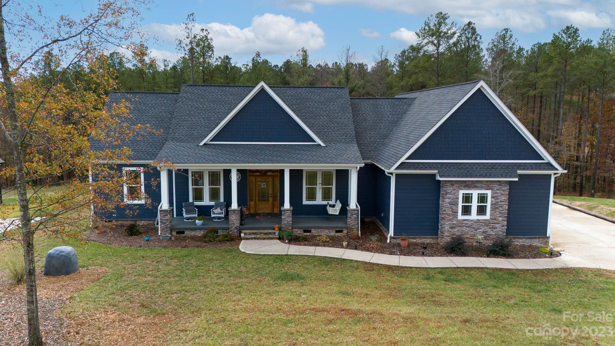 This remarkable 4 bedroom, 2.5 bath sanctuary is more than just a home. Step into a world where every detail speaks of passion and expertise. This home, lovingly constructed by the seller, features 10' ceilings, impeccable custom trim work, and a craftsman style design. The heart of this home is its kitchen with custom soft-close cabinets and a walk-in pantry. The primary ensuite boasts a free standing tub and custom, tiled rain shower. The hand built and designed closet is a haven for fashion enthusiasts with designated shoe racks. All this sits on 1.1 acres with views of Lake Wylie to sooth your soul. The stone fire pit area, deck, and sunroom are perfect spots to enjoy the beauty of the outdoors. There is no sign at the present time...will be replaced ASAP.