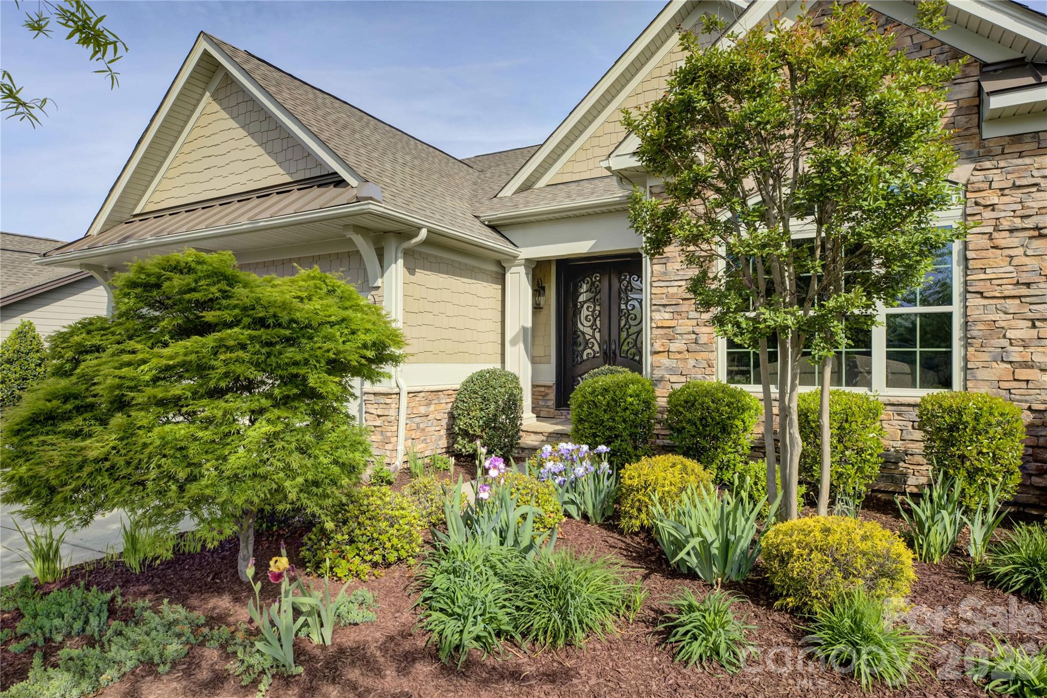 Located in the amenity-rich Regency at Palisades, just moments from the impressive clubhouse and amenity center, this beautifully appointed home welcomes you with a double-door entry featuring decorative glass panels that open into a grand two-story foyer. A formal sitting room or private study with arched windows fills the space with natural light, while the elegant dining room showcases classic wainscoting, a tray ceiling, and a charming bay window. The gourmet kitchen is a chef’s dream, with an oversized granite-topped prep island with a single-bay sink, a gas range with an exhaust hood, and abundant cream cabinetry, all flowing seamlessly into the breakfast area and out to a screened porch—perfect for enjoying Carolina’s mild seasons. The great room, anchored by a cozy gas fireplace, enhances the open-concept design ideal for both everyday living and entertaining. The luxurious primary suite features a tray ceiling, dual vanities, an oversized glass-enclosed shower, and a custom closet, while a main-level guest suite with a hall bath adds convenience. Upstairs offers a versatile loft with barn door, private office, and a third bedroom suite with full bath, providing flexible living space. Residents of Regency at Palisades enjoy resort-style amenities including a clubhouse, pool, fitness center, tennis and pickleball courts, and an active social calendar, all set within one of the area’s most sought-after communities.