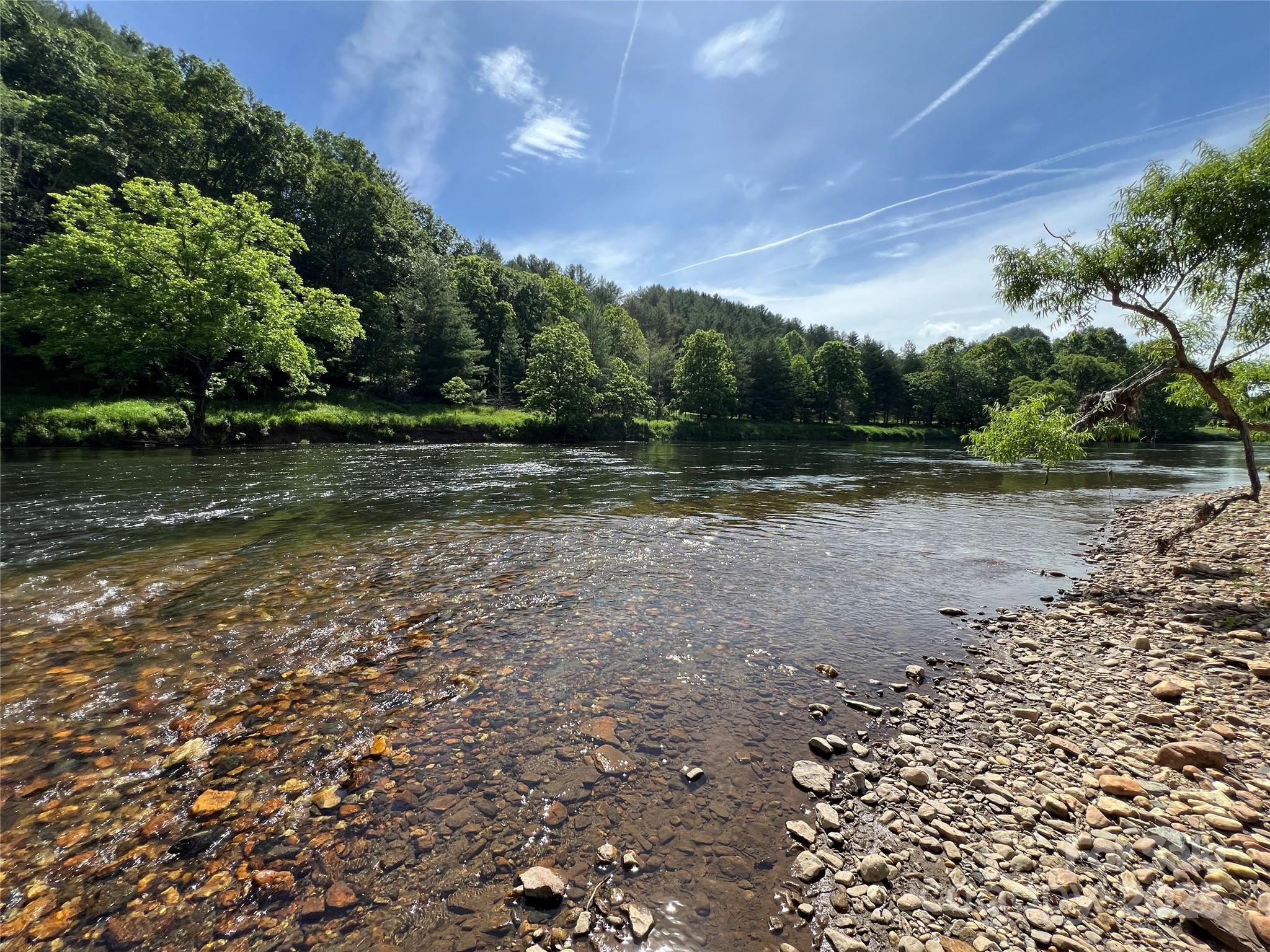 Riverfront recreational lot ready for you to come enjoy this summer. Level lot with easy access in and out of the river. Surrounded by mountain views and looking across the river at state owned land.

Bring your tents or campers and enjoy making memories along the banks of the South Fork of the New River. Come enjoy everything life in the High Country has to offer.

Popular nearby destinations include the New River State Park system, Blue Ridge Parkway, Grayson Highlands, and Virginia Creeper Trail. Centrally located a scenic 25 minute drive from West Jefferson or Sparta.

Drive time to CLT or Triad is less than 2 hours, and Raleigh 3.5 hours. Approximate property lines are marked with pink tape but should be verified by a licensed surveyor.