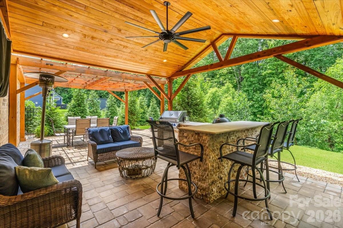 Gorgeous 5 bedroom/4 bath residence ideally positioned on a private, wooded and serene 0.34-acre lot in the highly sought-after, amenity-rich Summerwood community. With easy access to 485 and so many thoughtful upgrades including the best extended patio boasting an outdoor kitchen with grill, mini-fridge and bar seating, as well as a built-in fire pit area — all set against a serene wooded backdrop. Enjoy a fully fenced-in backyard designed for both privacy and entertaining, your friends may never want to leave, complete with mature trees lining the rear of the property.

A charming covered front porch opens to a light-filled interior where rich hardwood floors span the open-concept main level, seamlessly connecting the spacious living room, anchored by a striking brick fireplace, to the kitchen, dining area and sunroom.

The beautifully appointed kitchen features stainless steel appliances, soft-close cabinetry, a generous island, subway tile backsplash and abundant prep space. A main-level guest suite, private office with French doors and formal dining room add both flexibility and function to the home.

Upstairs, a versatile loft complements four additional bedrooms, including a privately situated primary suite features tray ceilings, 2 spacious walk-in closets and an enviable en-suite bath with a soaking tub, dual sink vanity and a beautifully tiled walk-in shower. Secondary bedrooms are generously sized sharing two full baths.  And a tankless water heater for added efficiency and never ending hot water. 

Residents of Summerwood enjoy access to an impressive array of amenities, including a clubhouse, resort-style pool, playground, scenic pond and walking trails, offering a lifestyle of comfort, connection, and convenience.

This house is ready to become your home sweet home!