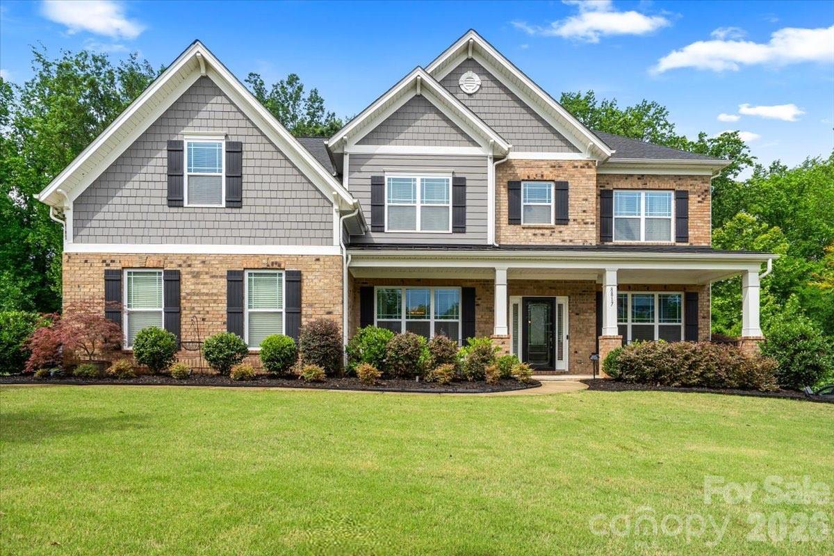 Gorgeous 5 bedroom/4 bath residence gracefully positioned on a private, wooded 0.34 acre lot within the highly sought-after, amenity-rich Summerwood community. A welcoming covered front porch sets the tone, opening into an elegant interior where rich hardwood flooring spans the light-filled, open-concept main level. The expansive living room, anchored by a striking brick fireplace, flows effortlessly into the kitchen, dining area and sunroom, creating a seamless environment for both everyday living and elevated entertaining!

At the heart of the home, the thoughtfully designed kitchen impresses with stainless steel appliances, soft-close drawers (throughout the home), a generous center island with seating, abundant cabinetry and prep space, and a timeless subway tile backsplash. The main level is further enhanced by a formal dining room, a private office with French doors and a well-appointed guest suite with a full bath, ideal for visitors or multigenerational living.

Upstairs, a versatile flex space offers endless possibilities, complemented by 4 additional bedrooms including a serene primary retreat. Privately situated, the primary suite features tray ceilings, 2 spacious walk-in closets, and an enviable en-suite bath with a soaking tub, dual sink vanity and a beautifully tiled walk-in shower. Secondary bedrooms are generously sized and share two full baths, while a dedicated laundry room adds everyday convenience.

Outside, you'll find an exceptional outdoor living experience, complete with a fully equipped kitchen featuring a built-in grill, mini refrigerator and bar seating. The extended patio provides ample space for dining and gathering, highlighted by a fire pit area overlooking a tranquil wooded backdrop, offering the ideal setting for year-round enjoyment.

Residents of Summerwood enjoy access to an impressive array of community amenities, including a clubhouse, resort-style pool, playground, scenic pond and walking trails, offering a lifestyle of comfort, connection and convenience!