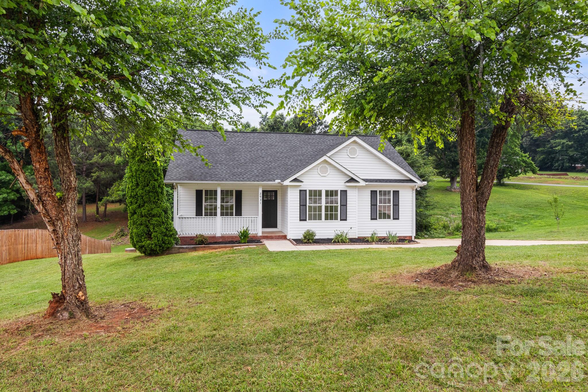 Find your happy place here at 2931 Greenleaf Rd! Step through the front door from the covered front porch into an open great room with vaulted ceilings. The floorplan allows effortless flow to the dining area and kitchen.  Kitchen has NEW stainless steel appliances, granite countertops, white cabinets, and sleek, modern fixtures. Just down the hall are the 3 bedrooms and convenient laundry closet. The Guest bathroom is in the hallway with Single granite vanity and Tub/shower combo. The primary bedroom has an elegant tray ceiling and large walk-in closet. The primary bathroom has a shower/tub combo, dual granite sink vanity, and linen storage closet. The HUGE back deck is a great space for entertaining and relaxing with beautiful, calming views of the trees at the back of the property. There is also a concrete patio on the ground level beneath the deck that can be used for storage, additional seating in shade, and more! Brand new windows are on order, expected to be installed within a few weeks! Come enjoy the comforts of living in the country!!