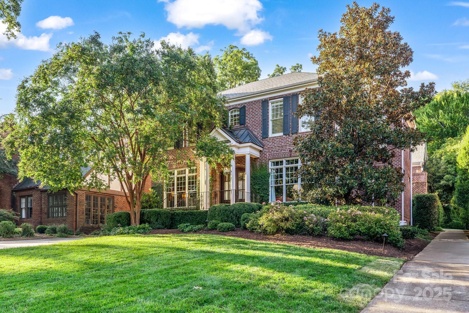 This timeless Myers Park residence offers over 5,000 square feet of elegant living space on a perfectly level, professionally landscaped .39-acre lot. From the moment you step into the gracious foyer, you’re greeted with soaring 10-foot ceilings, exquisite moldings, gleaming hardwood floors, and the rare feature of dual staircases that set the tone for the home’s grandeur.

The open floorplan is designed with both everyday living and grand entertaining in mind. The chef’s kitchen is a dream complete with Wolf range, Sub-Zero refrigerator, walk-in pantry, and butler’s pantry for seamless hosting. A spacious breakfast area opens directly to the family room with fireplace, creating a warm and inviting heart of the home. French doors lead to the enclosed outdoor patio where a brick fireplace and built-in grilling station create an ideal space for entertaining friends and family year round.

The main level owner’s suite is a true retreat, featuring a sitting room, custom his-and-hers walk-in closets, and a newly remodeled spa-like bathroom with dual vanities, luxurious soaking tub, and separate tiled shower. Upstairs, the front staircase leads to three spacious bedrooms with ensuite baths and a large bonus room, perfect for a playroom, media room, or home gym. The rear staircase offers private access to two additional bedrooms and a full bath, along with a versatile office or flex space complete with a built-in wine and beverage fridge, an ideal setup for a nanny suite, in-law suite, or private workspace.

Outdoors, the property has been thoughtfully designed for both beauty and function. The backyard is professionally landscaped with a stone terrace wall and expansive patio, while the fenced rear yard is fully turfed and includes a custom putting green. There is also ample space to add a pool if desired. Additional highlights include a whole-house generator for peace of mind and a fully encapsulated crawlspace for comfort and efficiency.

This home’s combination of timeless elegance, modern upgrades, and exceptional functionality makes it a rare find in one of Charlotte’s most coveted neighborhoods. With its proximity to parks, schools, shopping, and the cultural amenities of Uptown, this Myers Park gem offers not just a home, but a lifestyle.