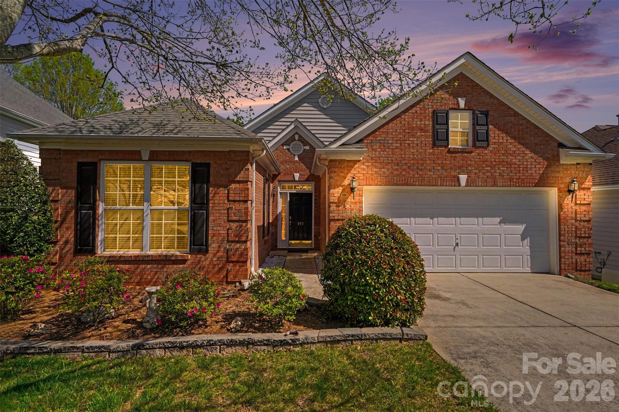 Welcome home to this beautifully maintained ranch, now featuring fresh updates that enhance both style and comfort. The open floor plan showcases a spacious living area centered around a cozy gas fireplace—now updated with a freshly painted finish—creating the perfect spot to relax or entertain. Brand new LVP flooring (2026) flows throughout the main living areas, complemented by updated lighting for cohesive feel.

The bright kitchen offers white cabinetry and ample counter space, seamlessly connecting to the dining area and sunroom—an inviting space for morning coffee or unwinding with a view. Step outside to a stunning hardscaped backyard with a paver patio and mature privacy trees, providing a peaceful outdoor retreat.

The split-bedroom layout offers a private primary suite, thoughtfully separated from the secondary bedrooms. Upstairs, an unfinished space above the garage with permanent stairs presents endless possibilities—perfect for a future bonus room, workshop, or additional storage.

Thoughtful updates, functional design, and room to grow—all in a welcoming community setting! Joing an amazing community with a wide variety of events and clubs!