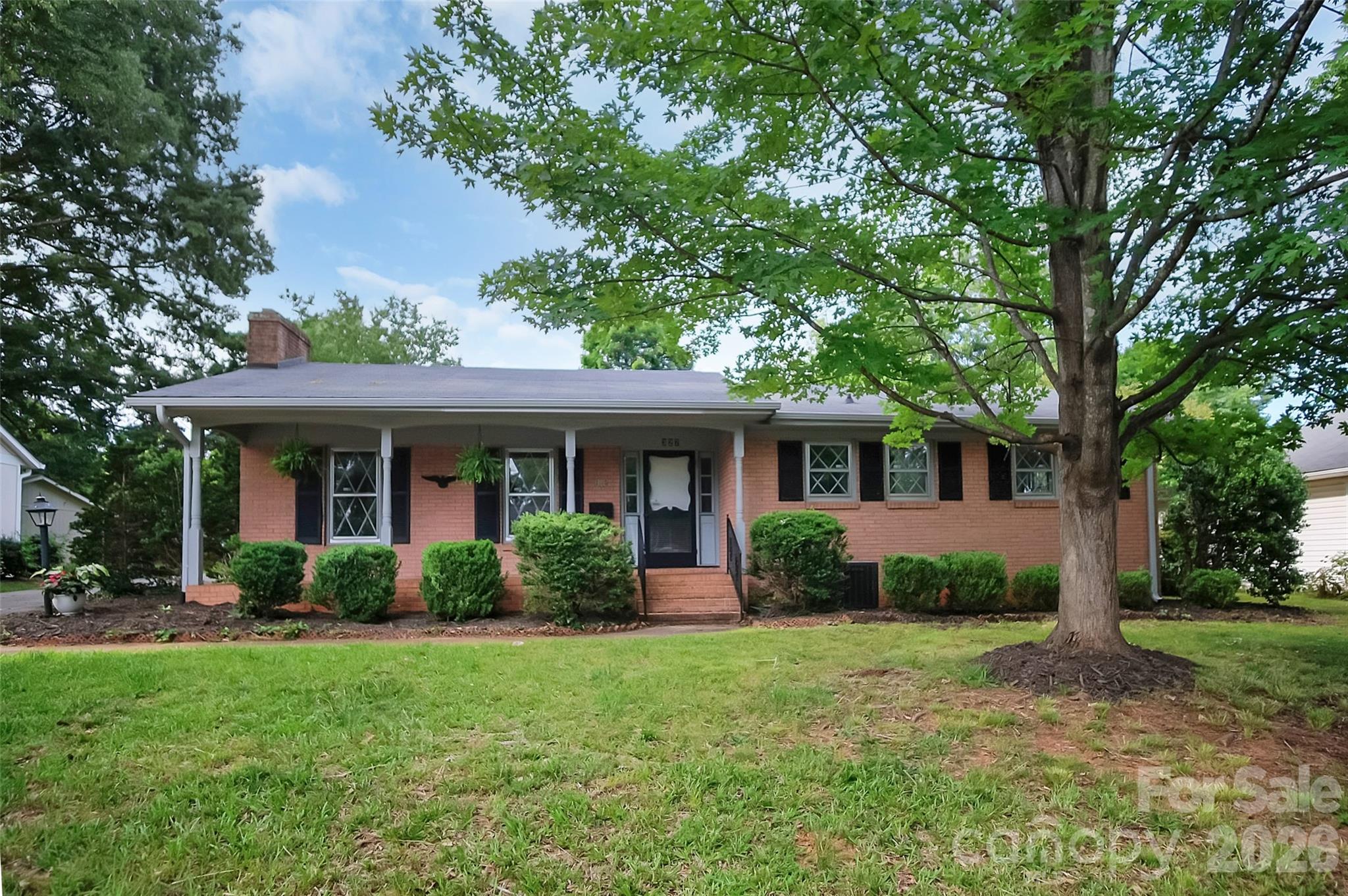 Welcome home to this charming brick ranch nestled in the heart of Forest City! Featuring 2 bedrooms and 2 full bathrooms, this well-maintained home offers comfortable living with numerous updates, including fresh paint and attractive laminate flooring throughout much of the home.

The inviting covered front porch provides the perfect spot to enjoy your morning coffee or unwind in a rocking chair at the end of the day. Inside, you'll find a spacious eat-in kitchen with plenty of room for gathering with family and friends. An attached carport adds everyday convenience, while the large backyard offers ample space for gardening, recreation, or pets.

A standout feature of this property is the impressive 20' x 20' metal building complete with a roll-up door—ideal for hobbies, storage, or workshop space—along with an additional 8' x 12' wooden storage building for even more flexibility.

Located just a 10-15 minute walk from vibrant downtown Forest City, you'll enjoy easy access to local restaurants, parks, shopping, entertainment, and community events. Plus, convenient proximity to US Highway 74 makes commuting and travel a breeze. Don't miss this opportunity to own a move-in-ready home in one of Forest City's most desirable locations!
