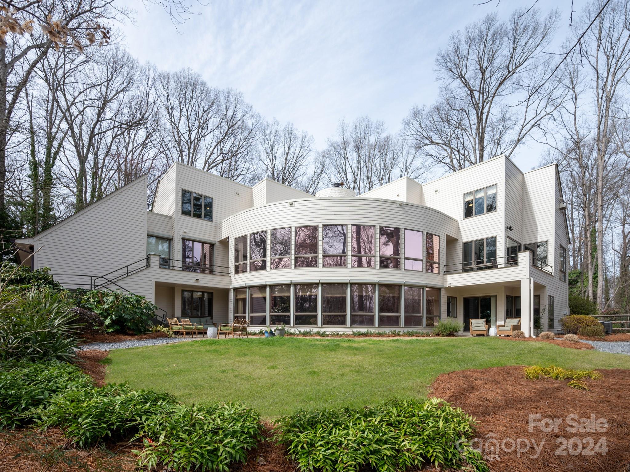 Why settle for the same Ordinary floorplan when you can have "Extraordinary".Immerse yourself in the timeless elegance of this spectacular Estate home.A masterpiece of modern architecture.Nestled in one of the sought after communities in Rock Hill, SC.The residence spans an impressive 7000+ sq.ft.Offers a harmonious blend of sophistication & contemporary design.The seamless integration of open spaces & sleek lines exemplifies the architectural brilliance.Spacious living areas, new gourmet kitchen w/ Cafe appliances, temperature controlled wine cellar;private sauna off Primary Bath; 2 home offices & expansive 2 story windows that invite natural light are just some of the highlights. Beyond the walls the property itself is a private sanctuary that encompasses 1.26 acres of lush landscaping.Embrace the opportunity to own a piece of architectural history & sit back & enjoy the recent improvements the homeowners have completed for you. One of the most impressive homes in the Charlotte area.