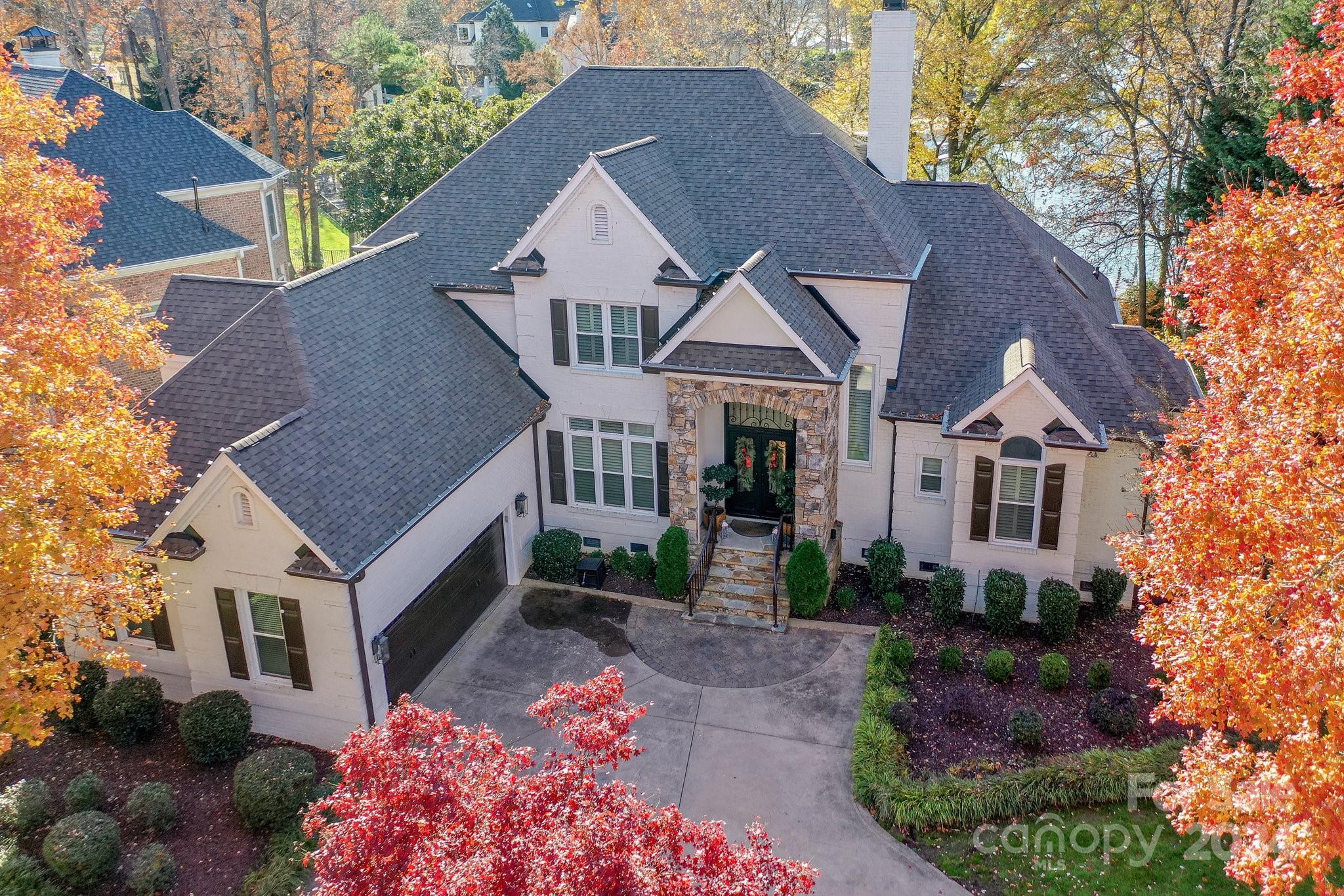 Luxury Waterfront living home w/Golf Course views in the prestigious Peninsula Community w/world class amenities! Experience this exquisite 5 bd/4.5 ba home w/open floorplan & walk-out basement. Enter through the iron doors into the spacious main level featuring: Stunning Great Room w/custom surround mantle, WViews from the Primary Suite w/renovated bath including freestanding tub & lakefront deck, a Chef's kitchen w/white cabinets, lg island, granite, Viking gas cooktop & oven w/custom hood, a bright Bkfst Area facing the water, & an airy Formal Dining Room. Upper level includes an office, 3 bdm/2 baths, & large walk in storage room. You'll enjoy entertaining from your walk-out basement w/its cozy living room w/fpl  & coffered ceiling, stone accents in the pull up bar & entertainment area w/sink, wine bev coolers, & a bdrm w/full bath.  Relax on your upper cov. porch or the outdoor patio w/a firepit. Covered dock with addl pergola to enhance the waterfront boating & living experience.
