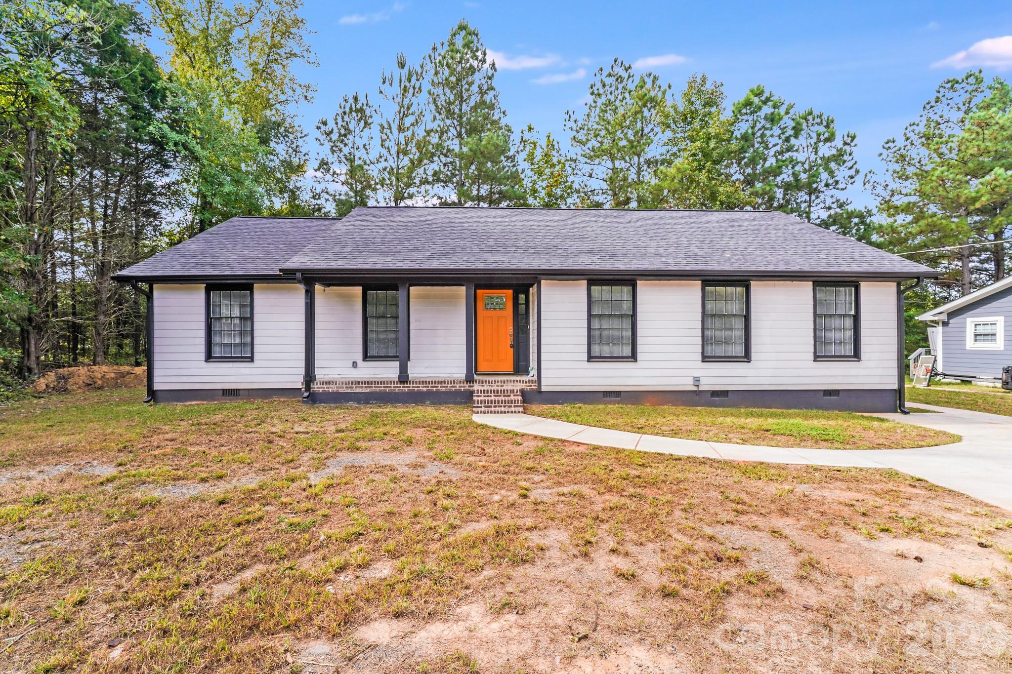 Investor Special - house is not in ready-to-live-in condition: This fabulous, updated ranch is perfectly situated just minutes from I-485, offering both convenience and tranquility. Step inside to discover a thoughtfully updated interior featuring a blend of stylish tile and warm wood flooring throughout. The kitchen shines with crisp white cabinetry, a modern white tile backsplash, and ample counter space—ideal for cooking and entertaining. Enjoy the serene, wooded backyard from your expansive deck, perfect for relaxing or hosting gatherings in a peaceful natural setting. Don't miss the chance to own this charming, updated home in a prime location! No functioning Well or Septic. Buyer will need to acquire portion of neighbor's property to allow current septic permit design to be completed.